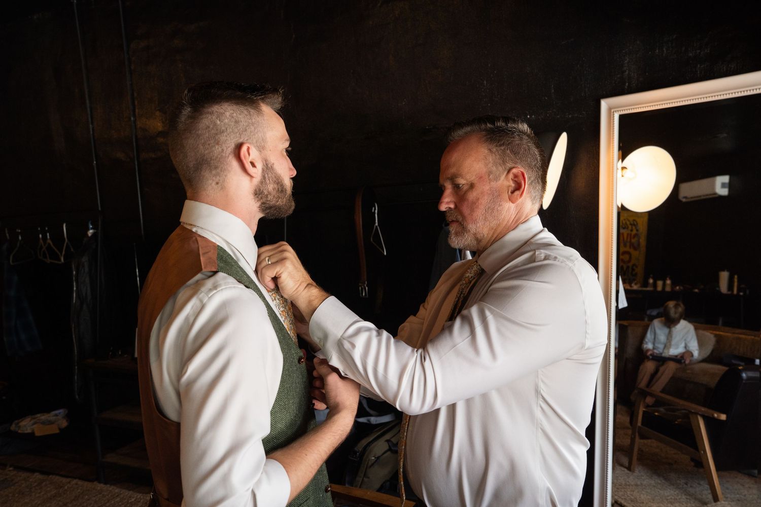 ©AnnaVonRiesenPhotography Wedding Photography | Color image of the groom's father helping him with his tie.