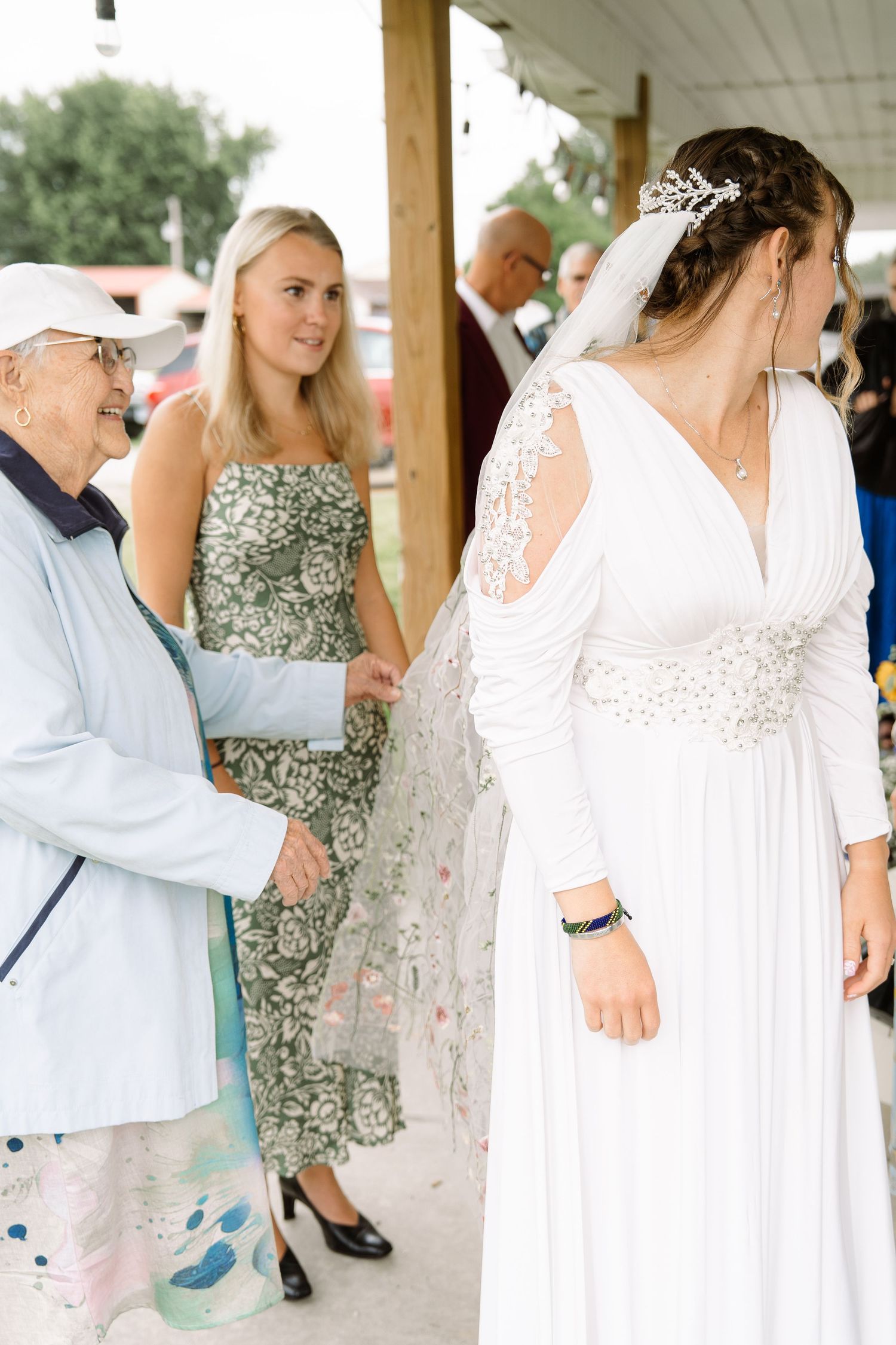 ©AnnaVonRiesenPhotography Wedding Photography | Color image of the bride's grandmother admiring her veil.