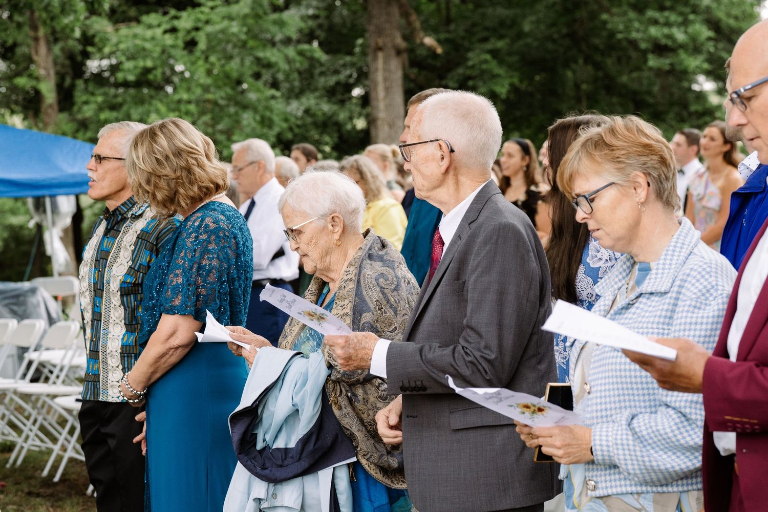 ©AnnaVonRiesenPhotography Wedding Photography | Color image of wedding guests worshipping.
