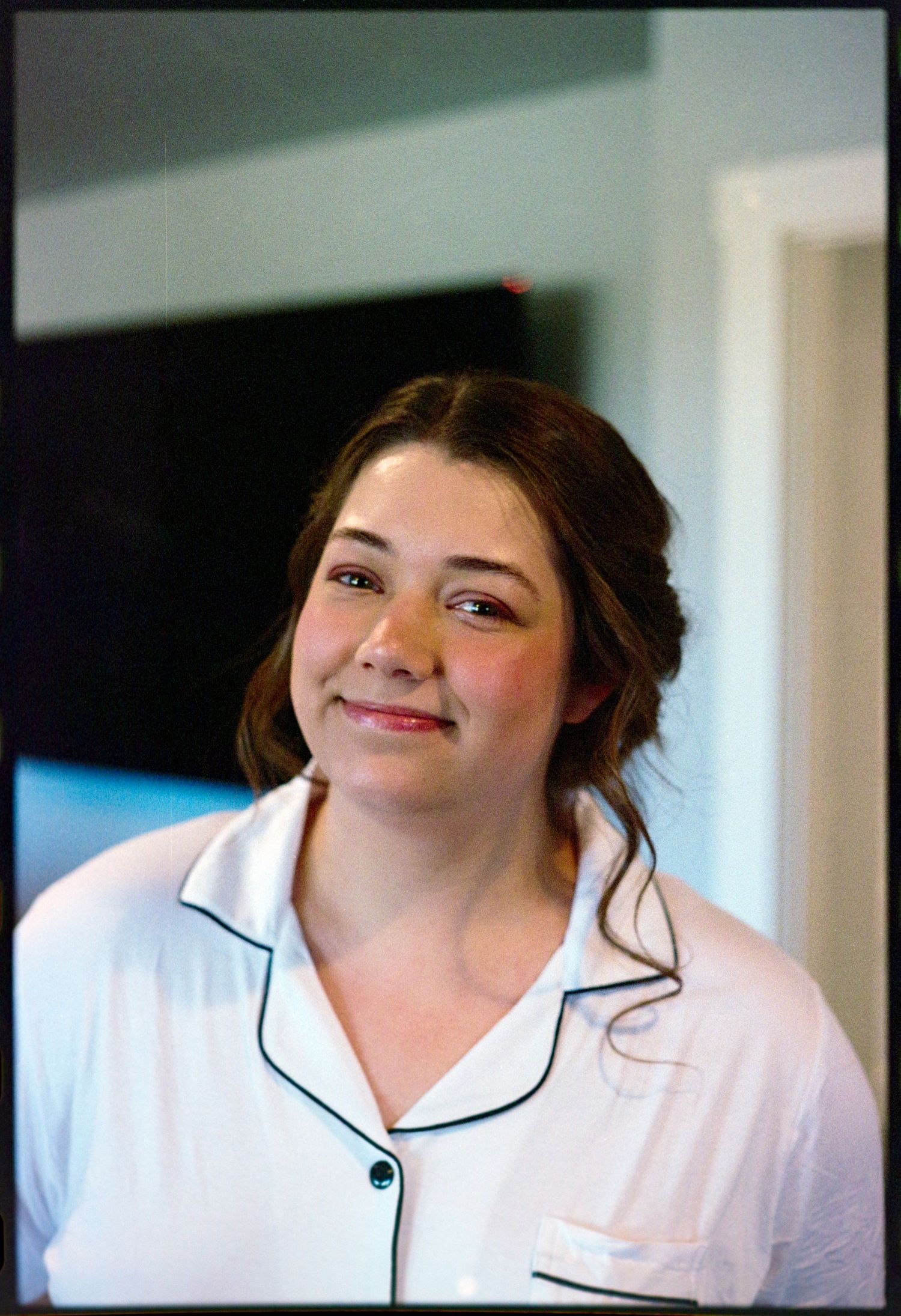 ©AnnaVonRiesenPhotography Wedding Photography | Film Color image of the bride smiling in her pjs.
