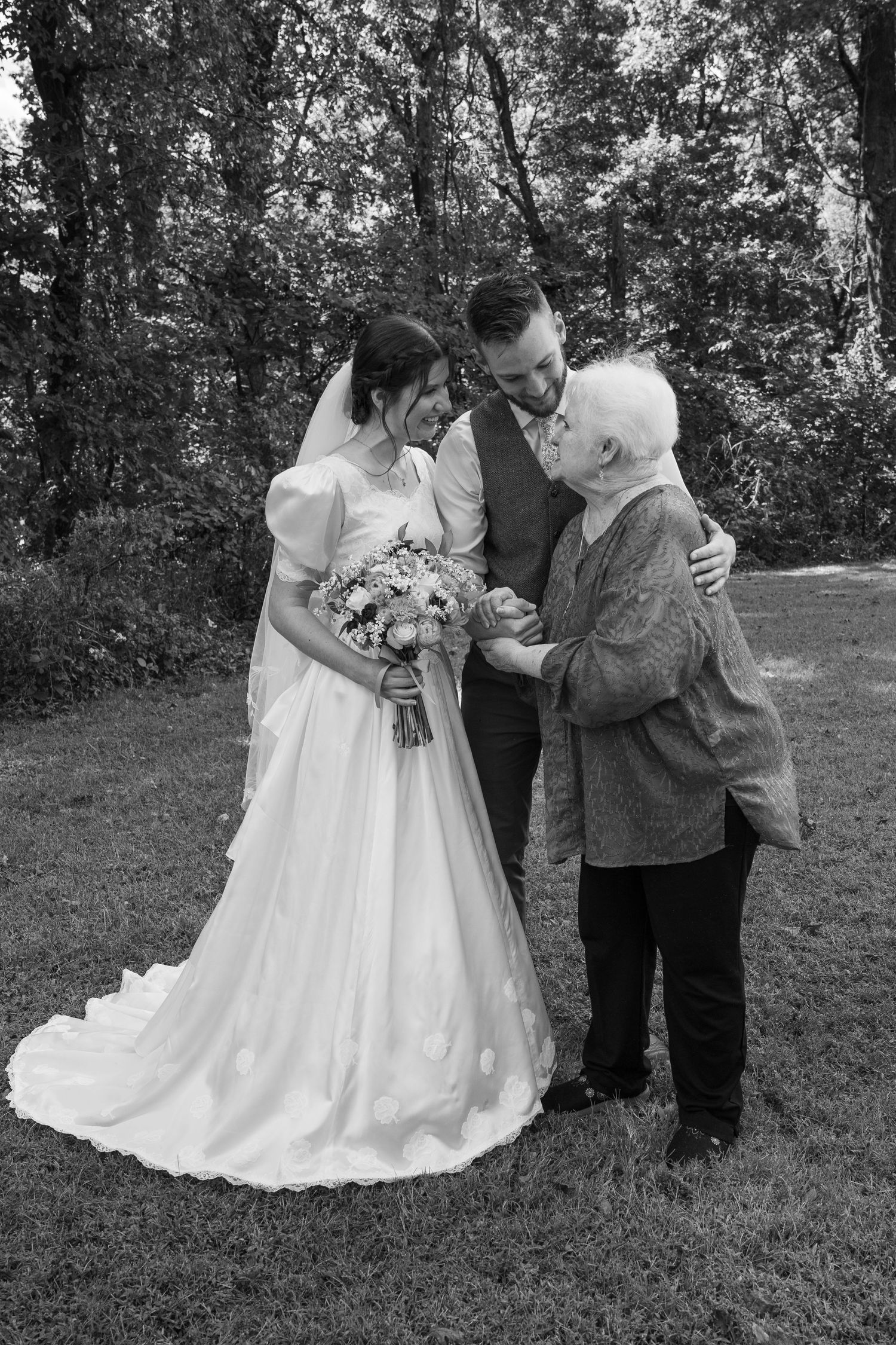 ©AnnaVonRiesenPhotography Wedding Photography | B&W image of the bride & groom talking with the groom's grandmother.