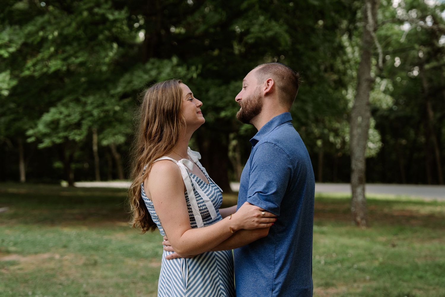 ©AnnaVonRiesenPhotography Engagement Photography | Color image of a couple holding each other & smiling.