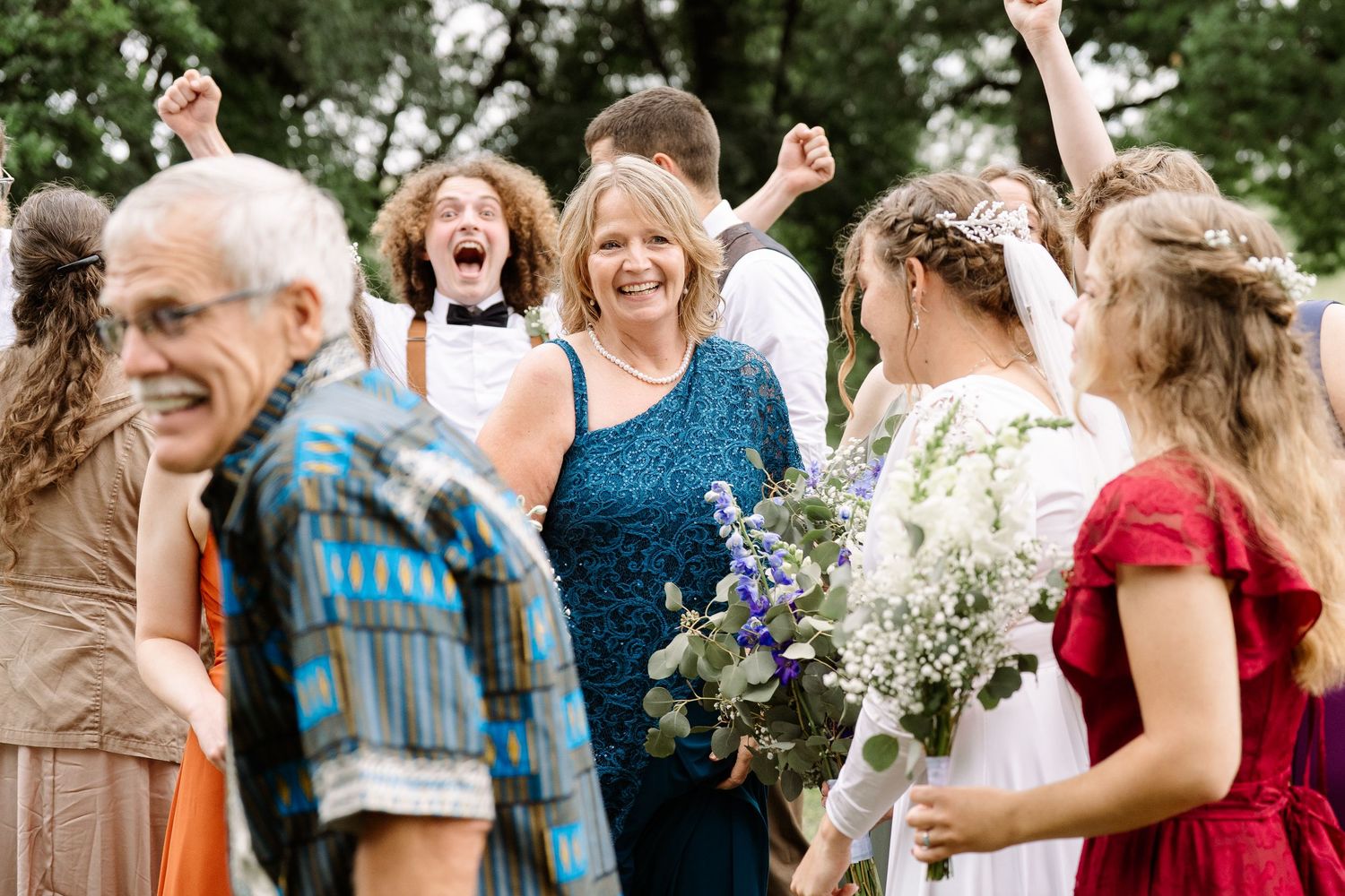 ©AnnaVonRiesenPhotography Wedding Photography | Color image of the family & bridal party celebrating together after the ceremony.