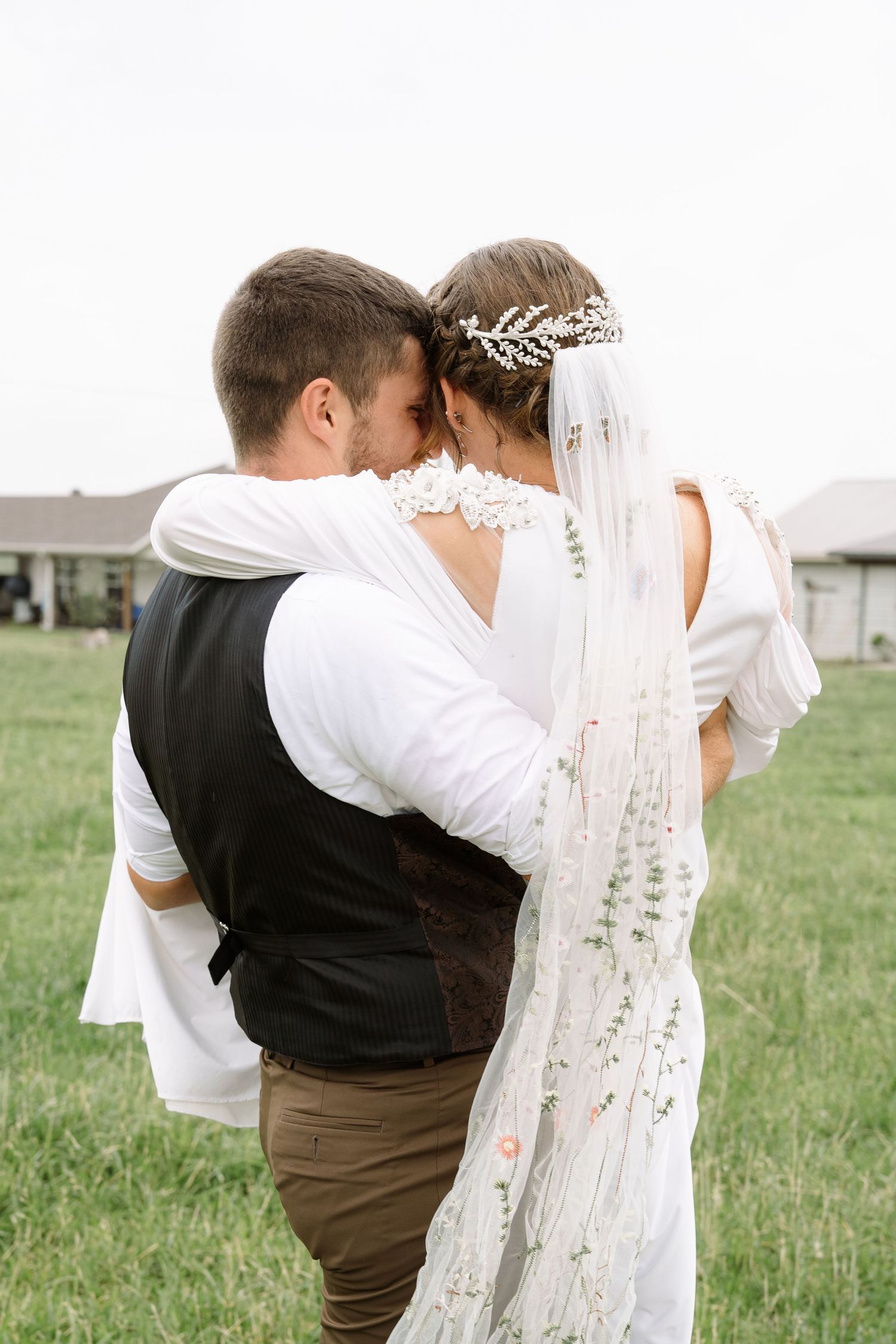 ©AnnaVonRiesenPhotography Wedding Photography | Color image of the groom sweeping his bride off of her feet.
