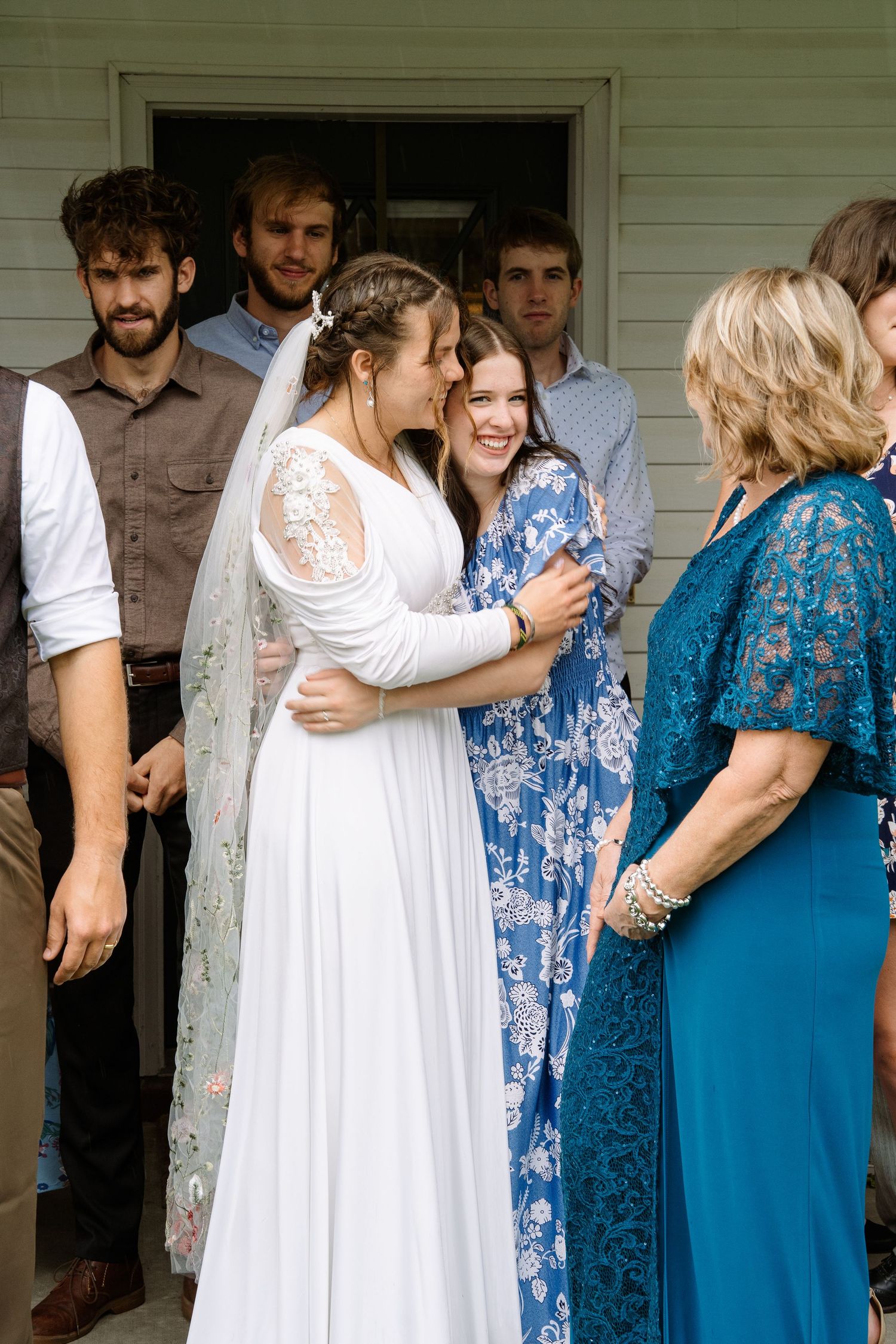 ©AnnaVonRiesenPhotography Wedding Photography |  Color image of the bride hugging a family member.