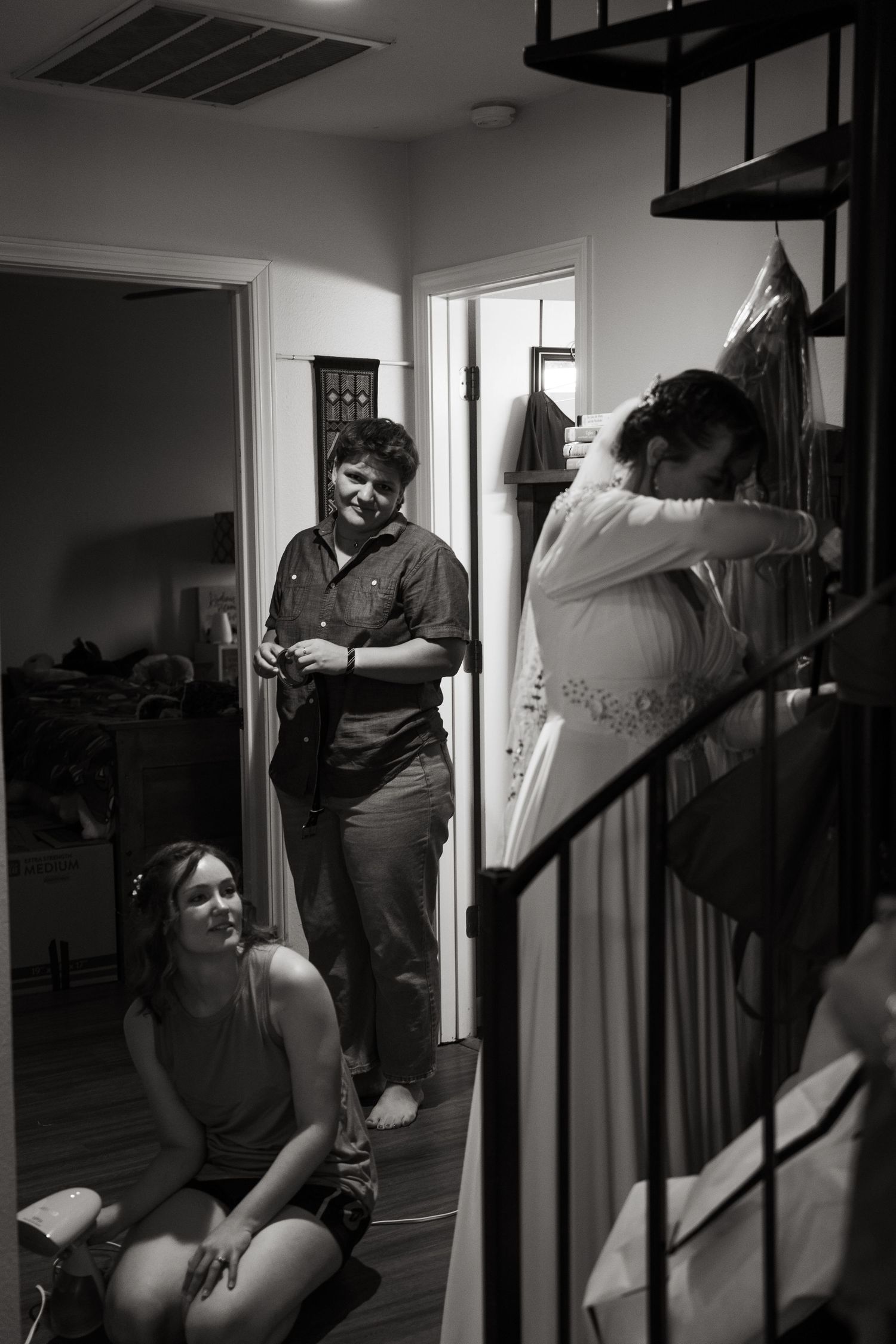©AnnaVonRiesenPhotography Wedding Photography | B&W image of the bride's sisters admiring her dress.