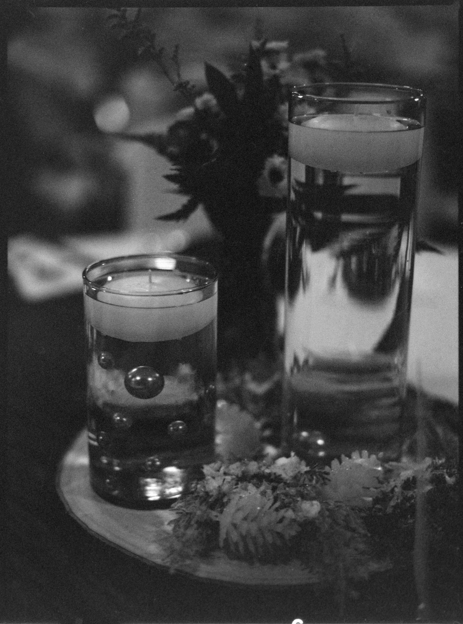 ©AnnaVonRiesenPhotography Wedding Photography | Film B&W image of reception details, candles and greenery.