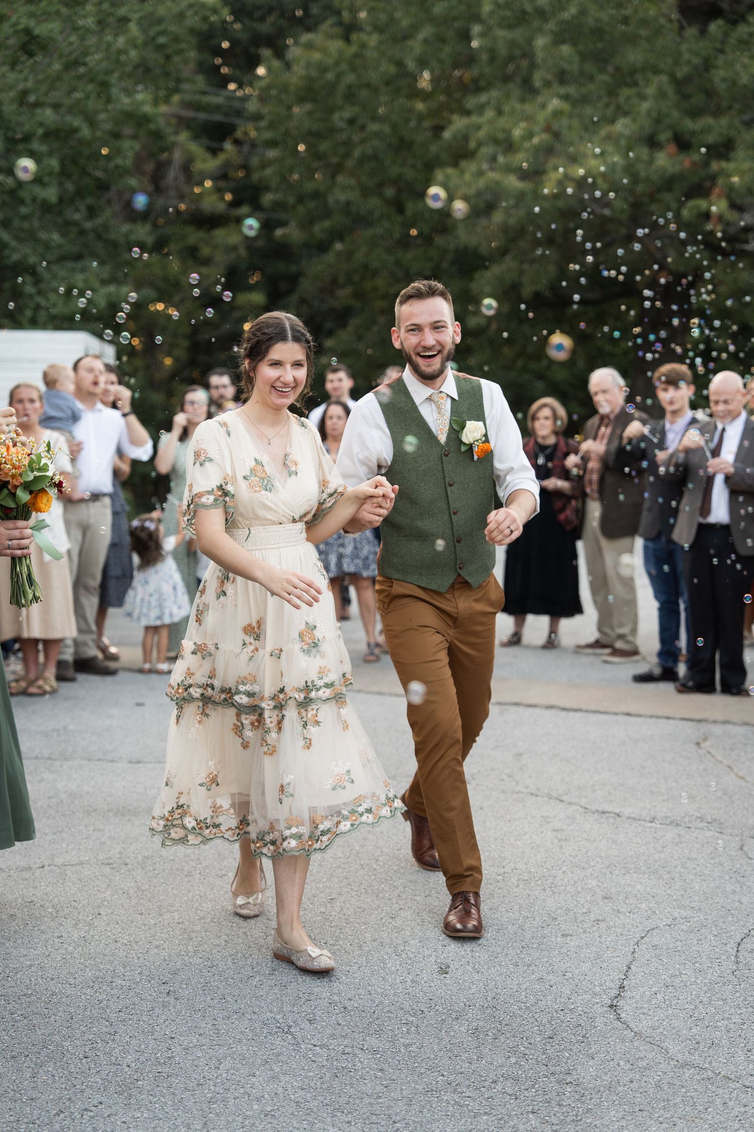 ©AnnaVonRiesenPhotography Wedding Photography | Color image of a bride & groom smiling while leaving their bubble exit.