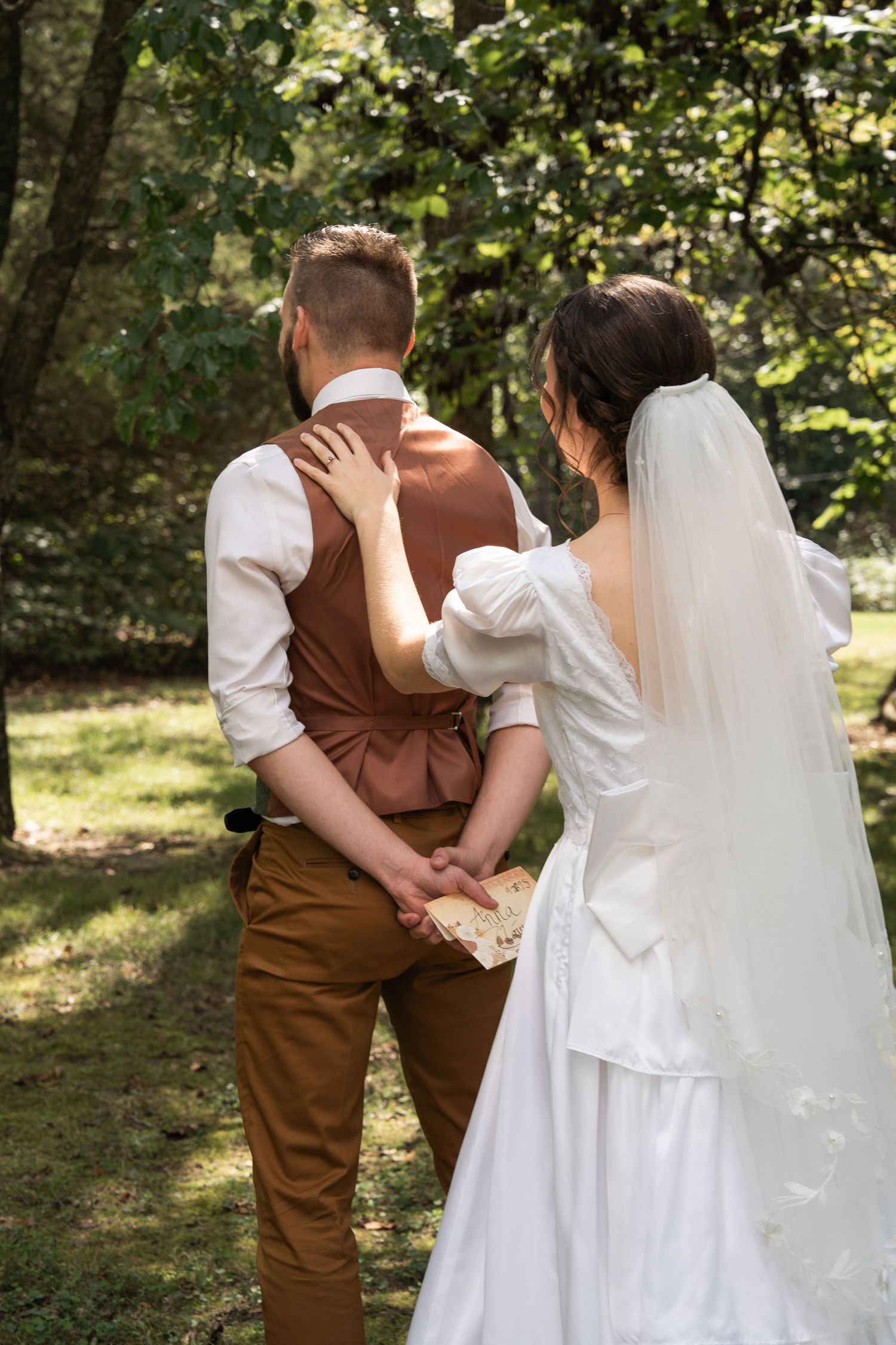 ©AnnaVonRiesenPhotography Wedding Photography | Color image of a bride tapping her groom on the shoulder during their first look.