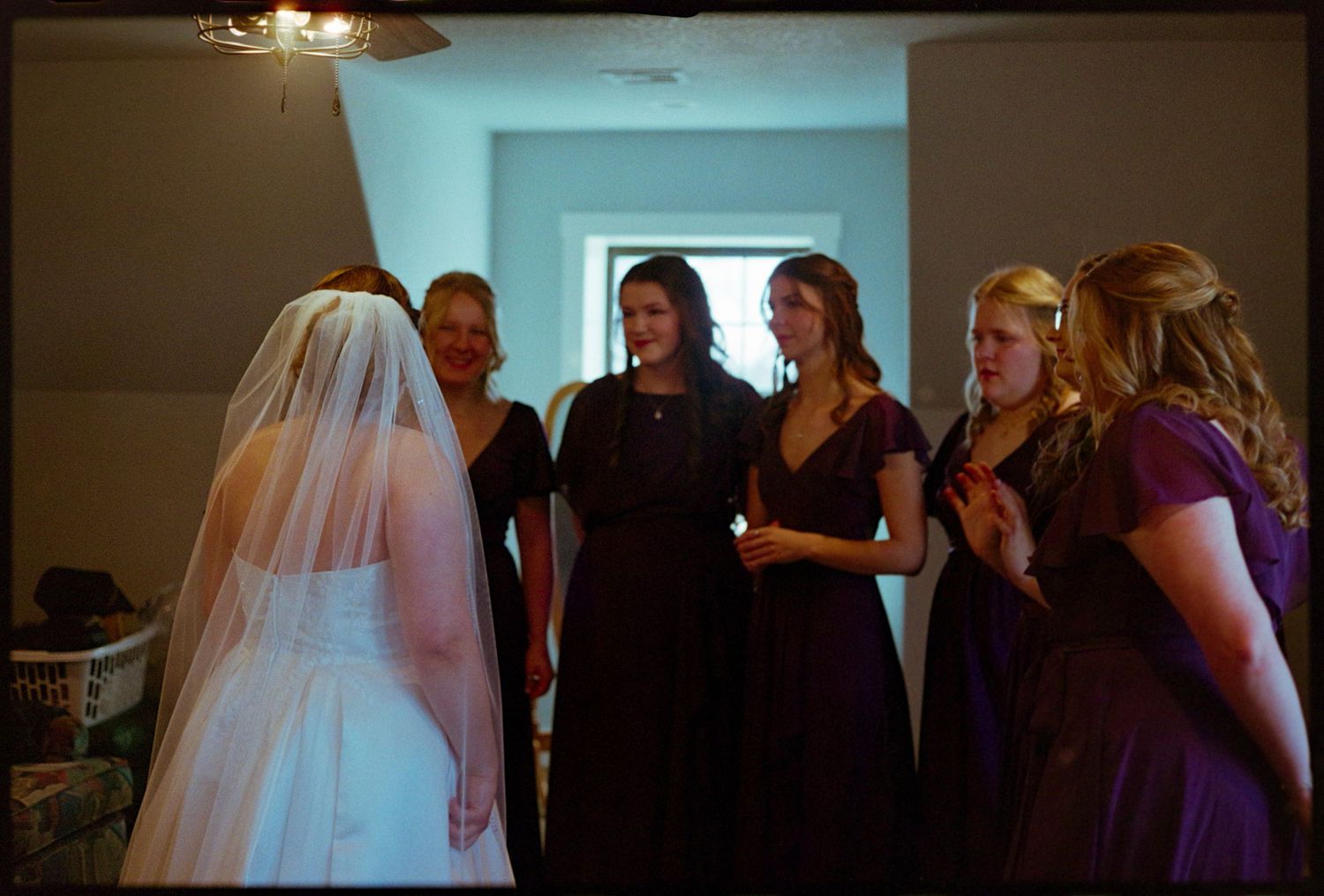 ©AnnaVonRiesenPhotography Wedding Photography | Film Color image of the bridesmaids reacting to the bride.