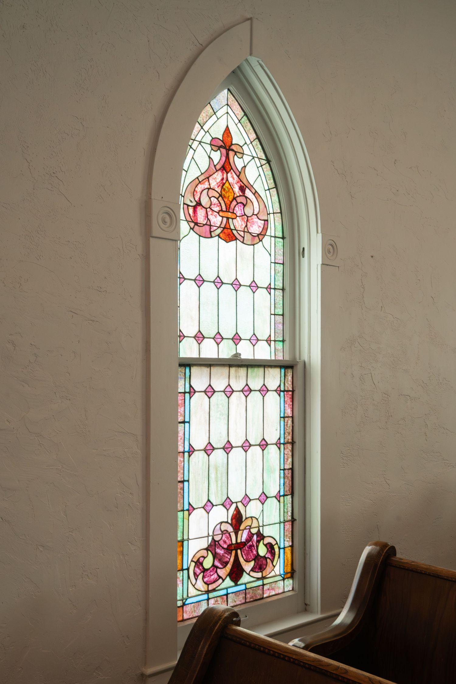 ©AnnaVonRiesenPhotography Wedding Photography | Color image of a stained glass window in a chapel.