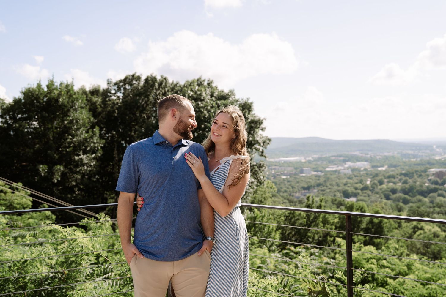 ©AnnaVonRiesenPhotography Engagement Photography | Color image of a woman looking at her fiancé over his shoulder.