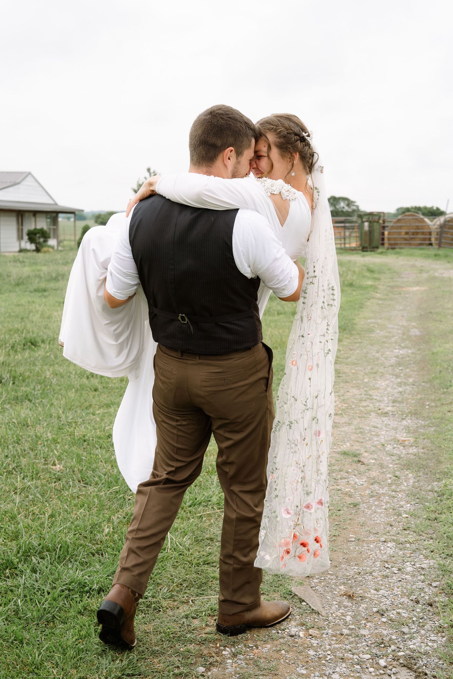 ©AnnaVonRiesenPhotography Wedding Photography | Color image of the bride being carried by her groom.