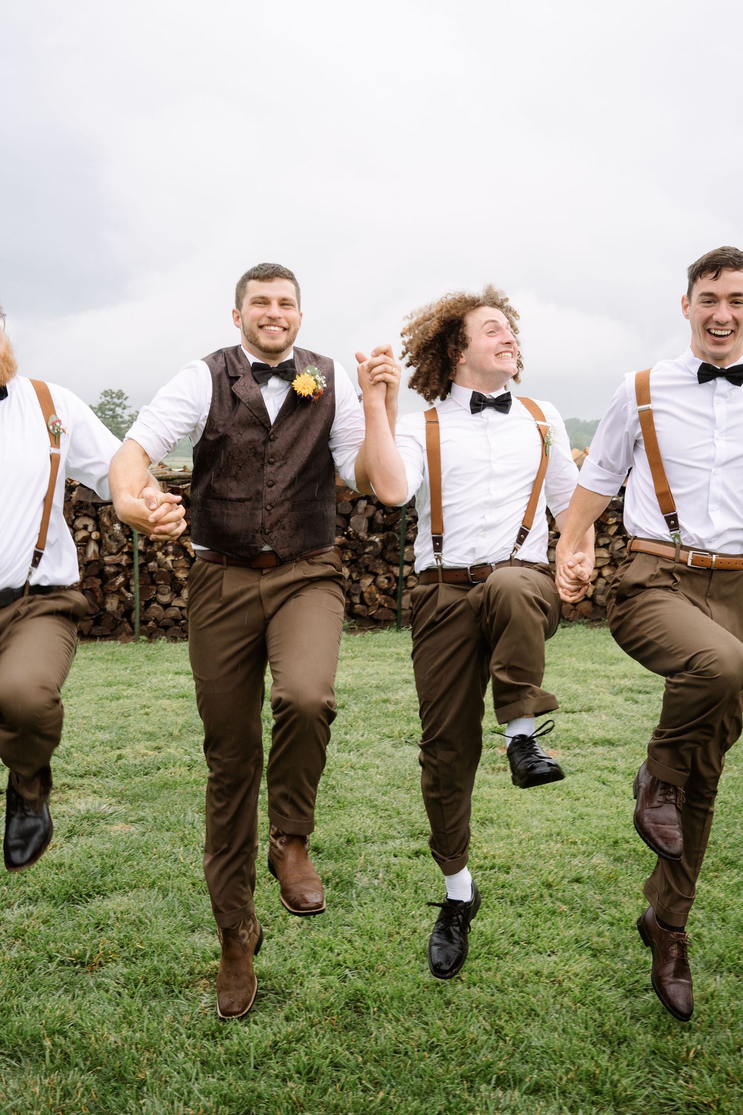 ©AnnaVonRiesenPhotography Wedding Photography | Color image of the groomsmen skipping and jumping.