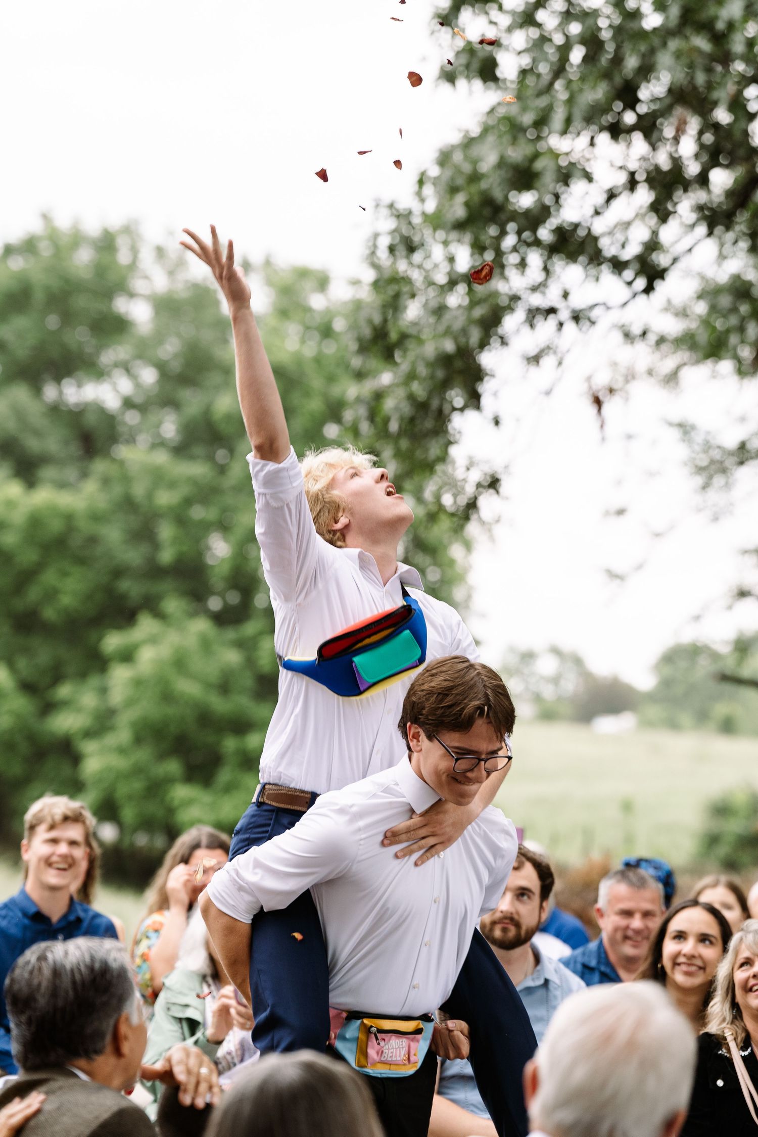 ©AnnaVonRiesenPhotography Wedding Photography | Color image of the flower boys tossing flowers.