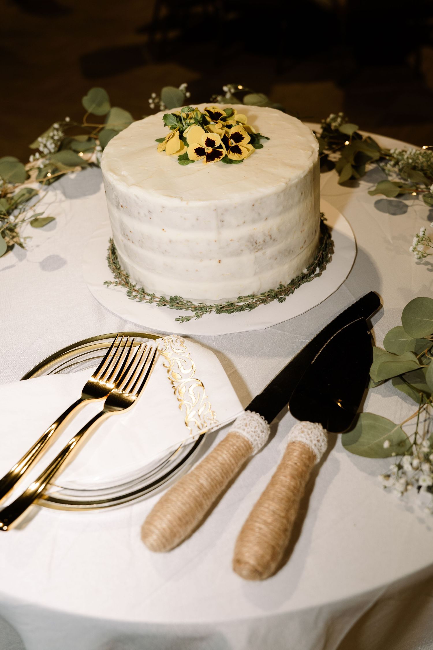 ©AnnaVonRiesenPhotography Wedding Photography | Color image of the cake with cutting utensils.