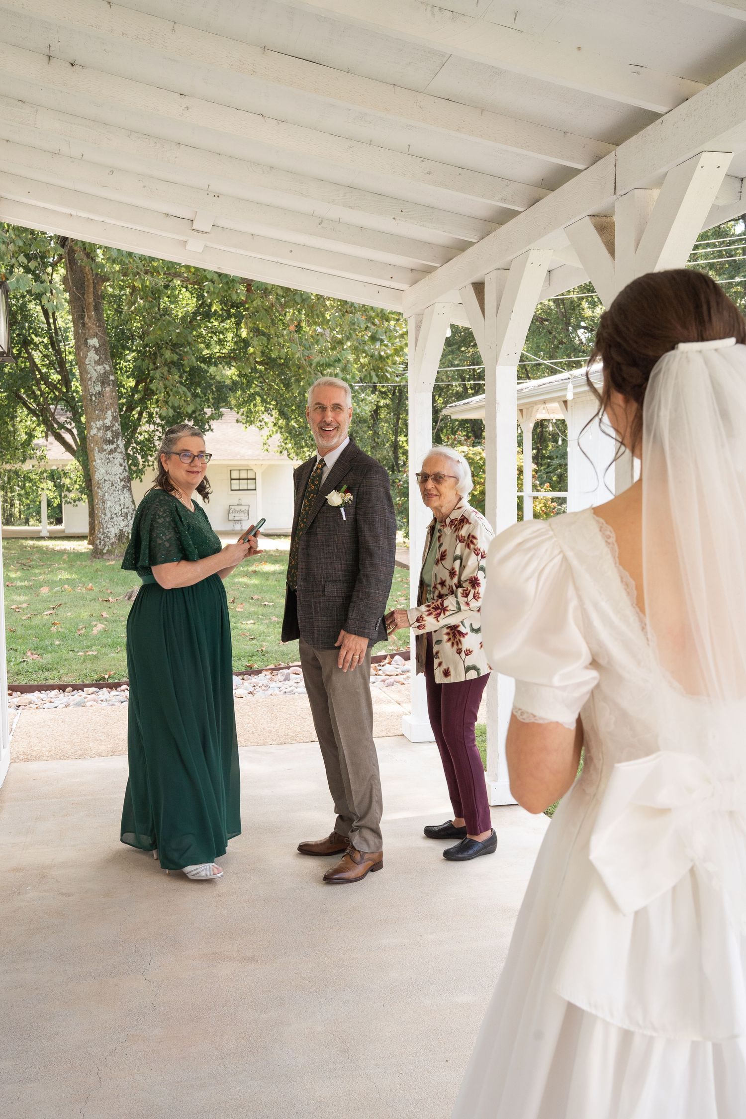 ©AnnaVonRiesenPhotography Wedding Photography | Color image of the bride sharing a first look with her parents and grandmother.