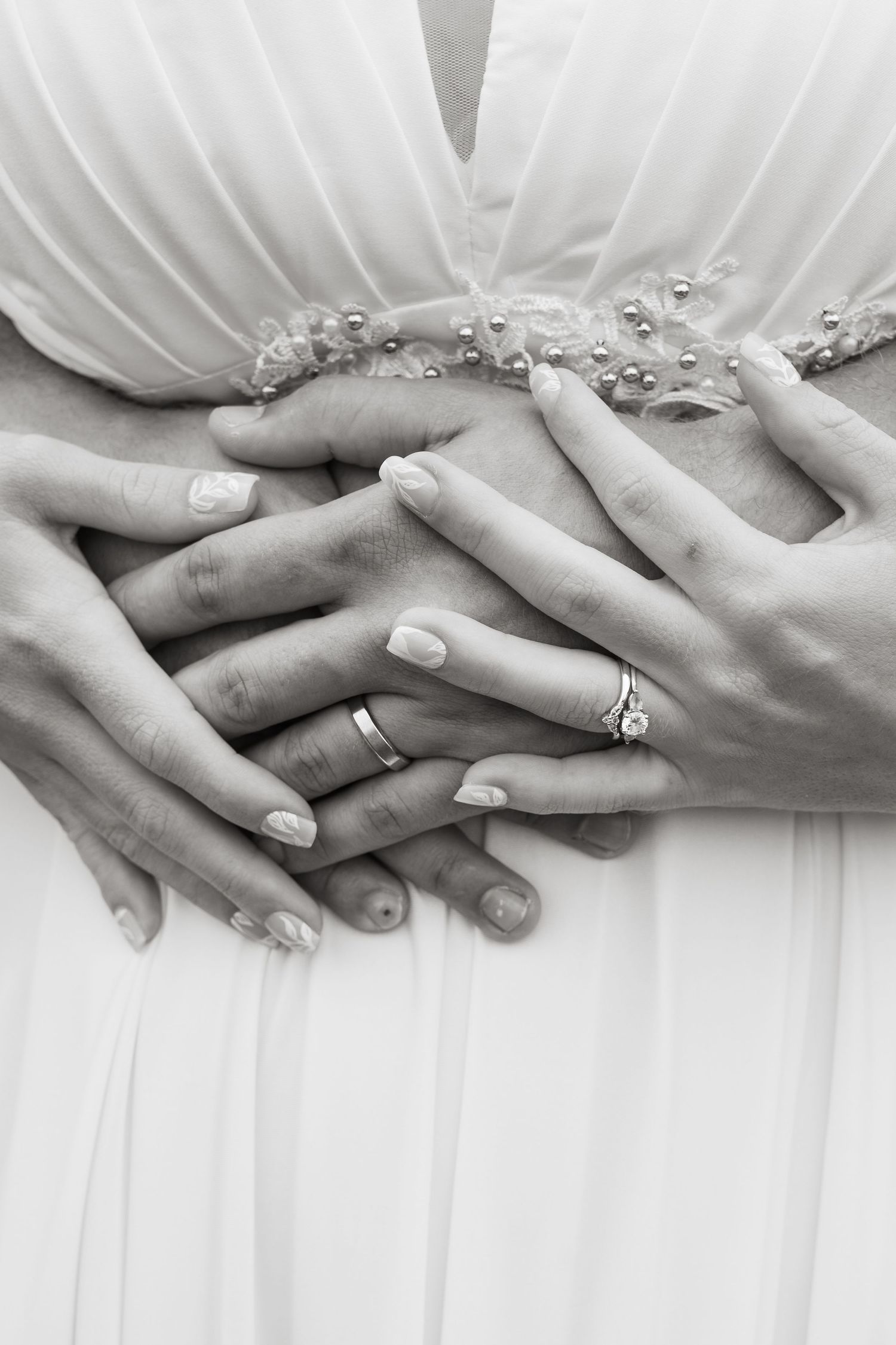 ©AnnaVonRiesenPhotography Wedding Photography | B&W image of the bride and groom intertwining hands & showing their rings.