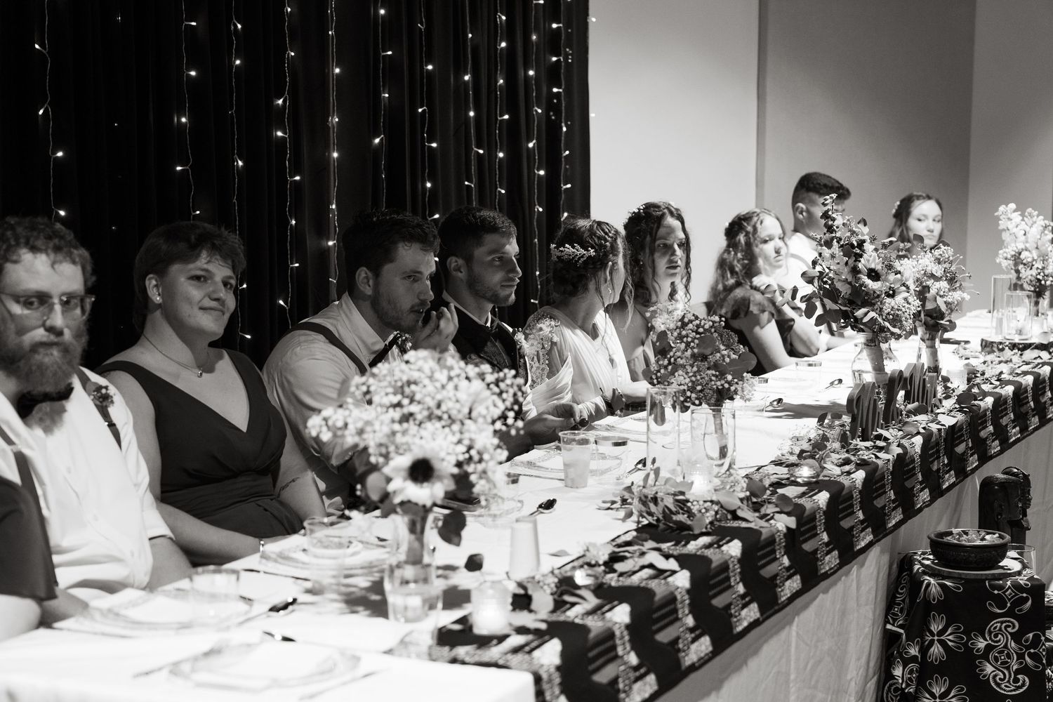 ©AnnaVonRiesenPhotography Wedding Photography |  B&W image of the bridal party eating dinner at the head table.