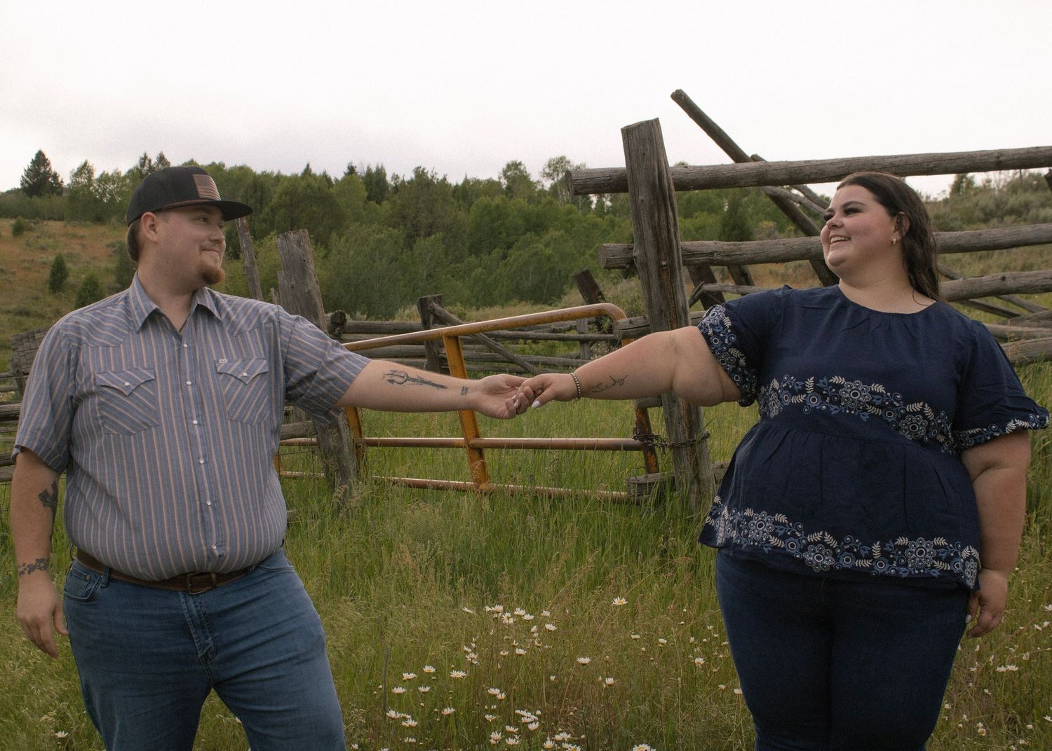Couple holding hands in canyon flower field
