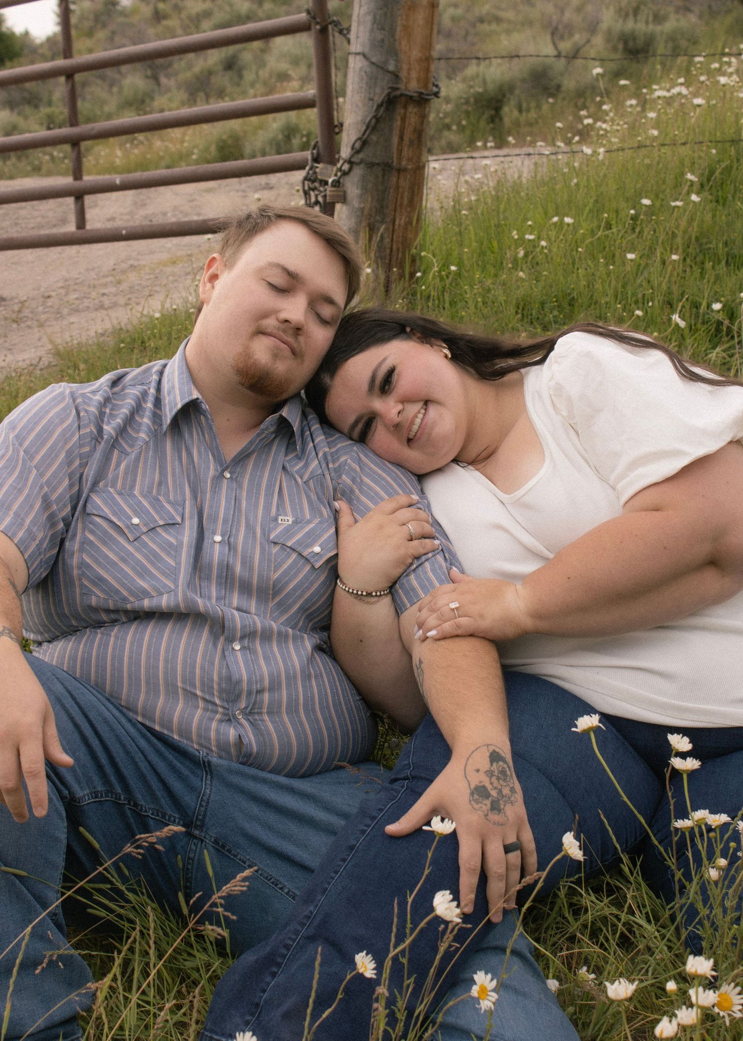 Couple snuggling in flower field engagement photos
