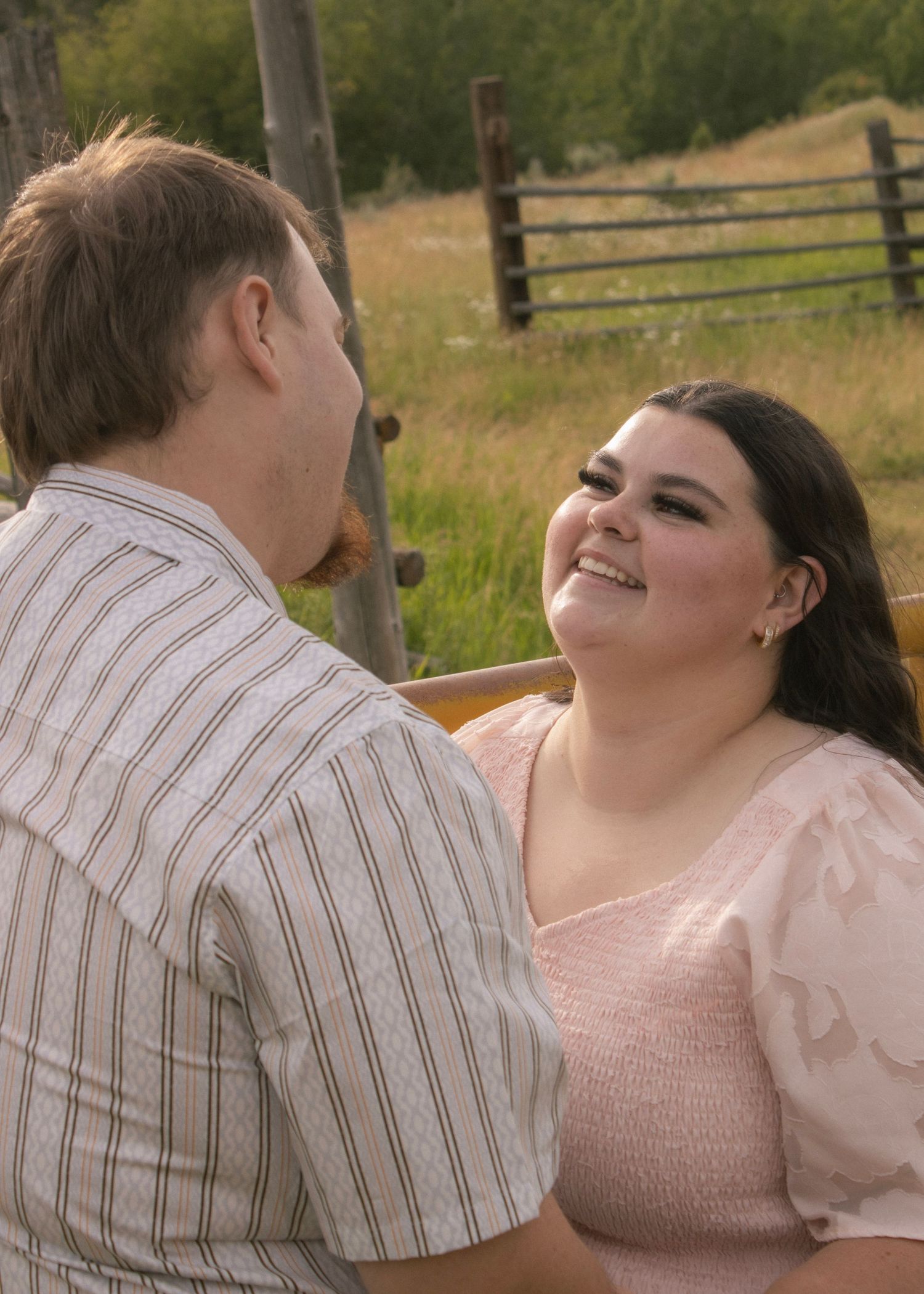 Couple laughing together in a flower field canyon