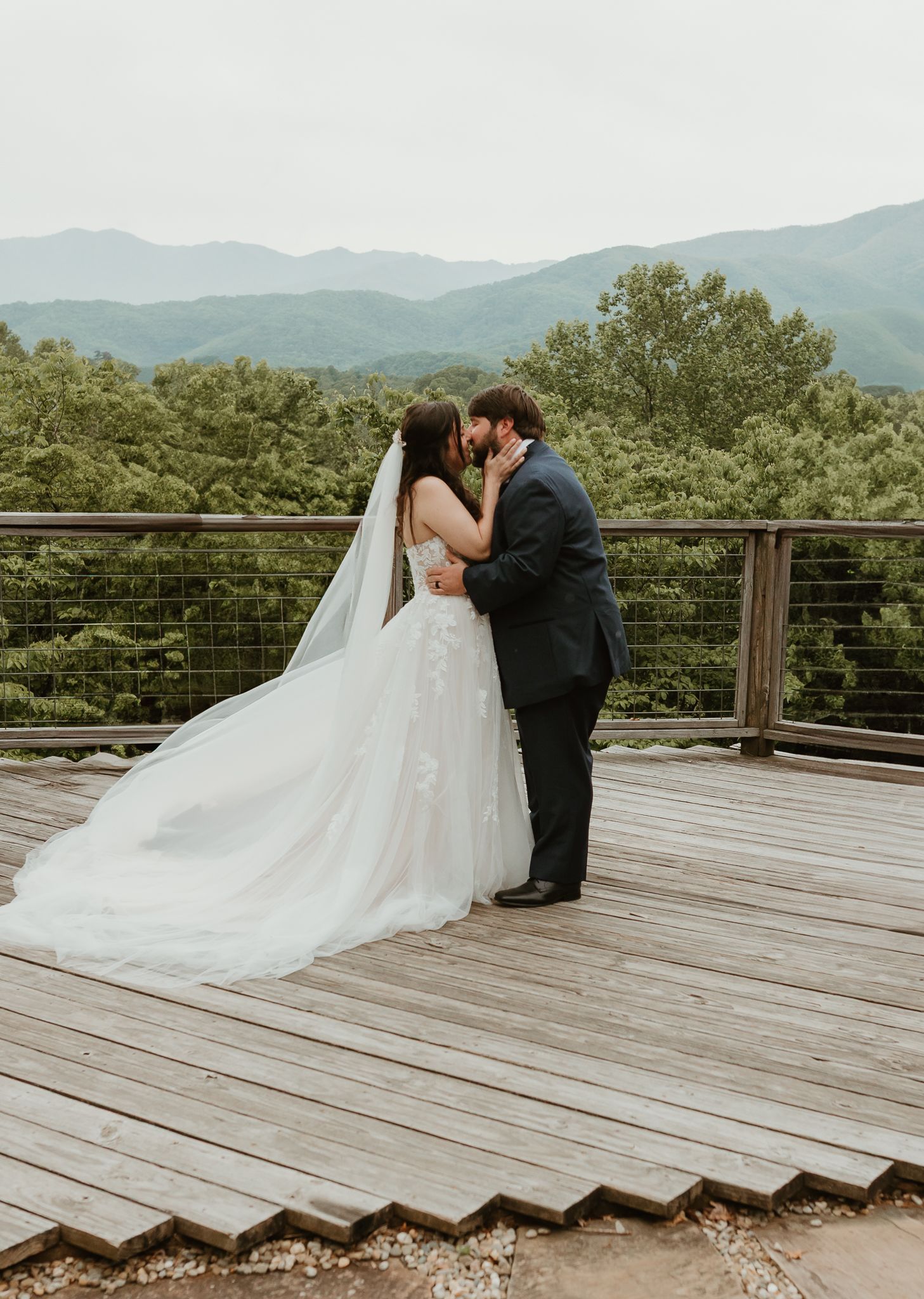 Romantic moment captured on a wooden deck overlooking mountain vistas Chattanooga Wedding Photographer