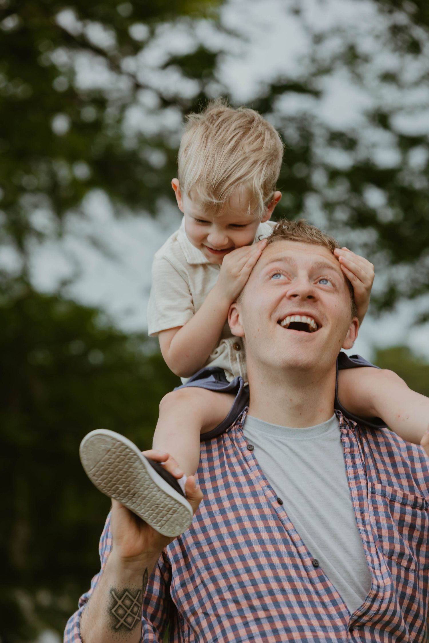 A playful piggyback ride moment captured during outdoor family photoshoot.