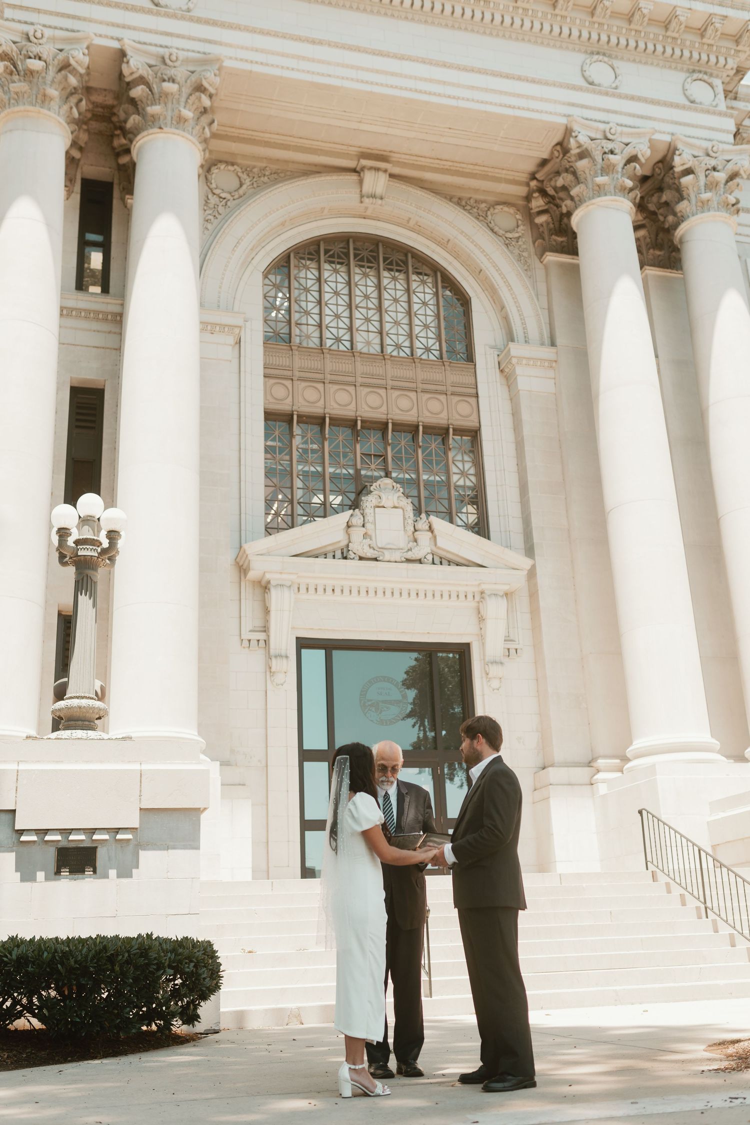 Elegant white columned building entrance with classical architecture details.
