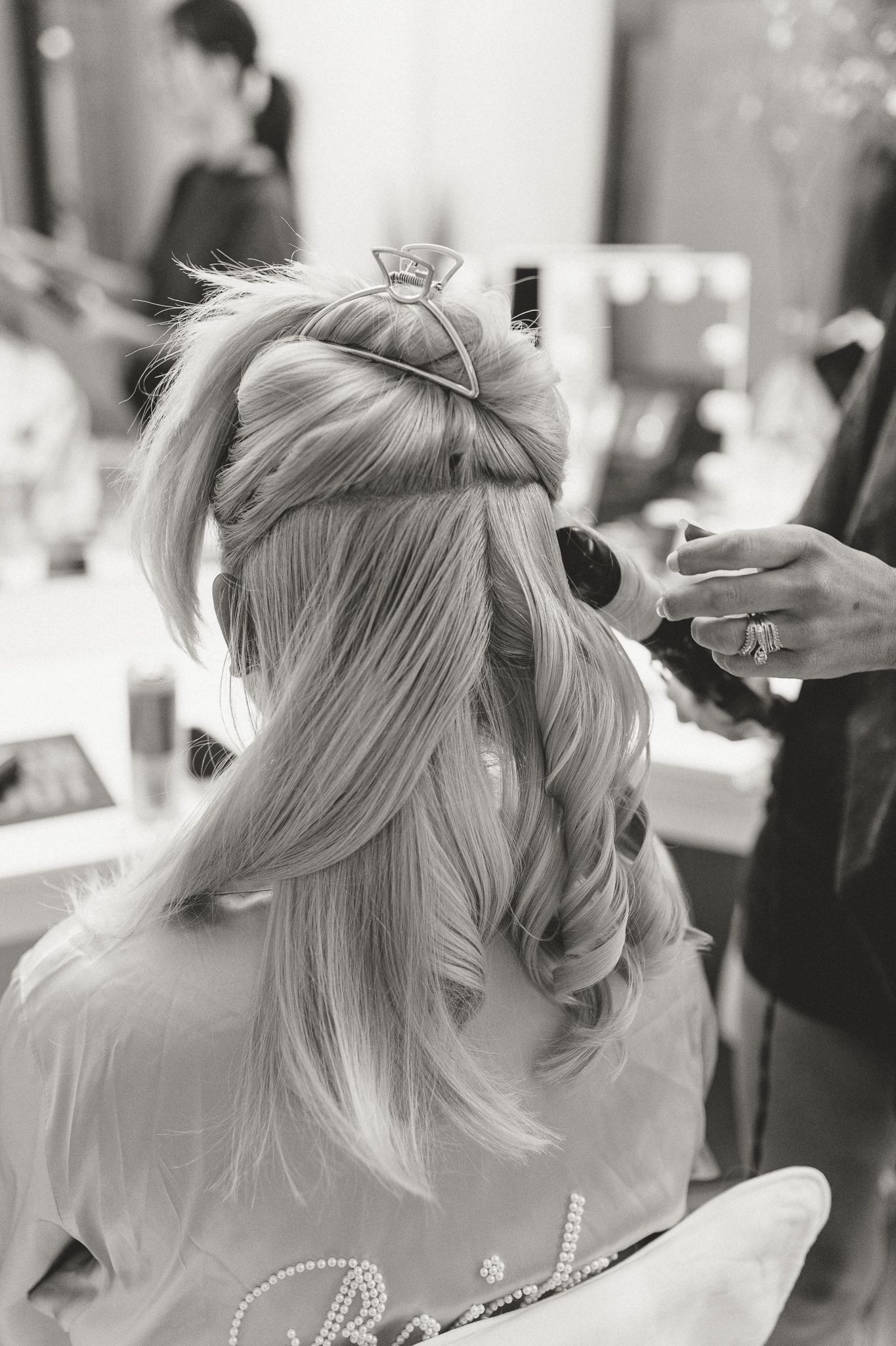 Close-up shots of elegant bridal hairstyling with pearl accessories.