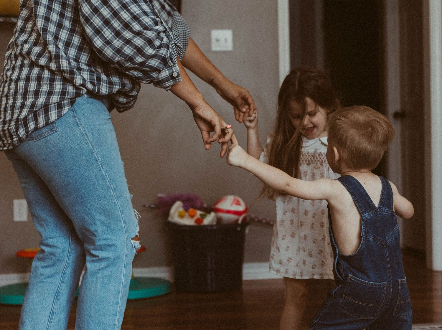 Series showing playful interactions between parent and child in casual home setting.