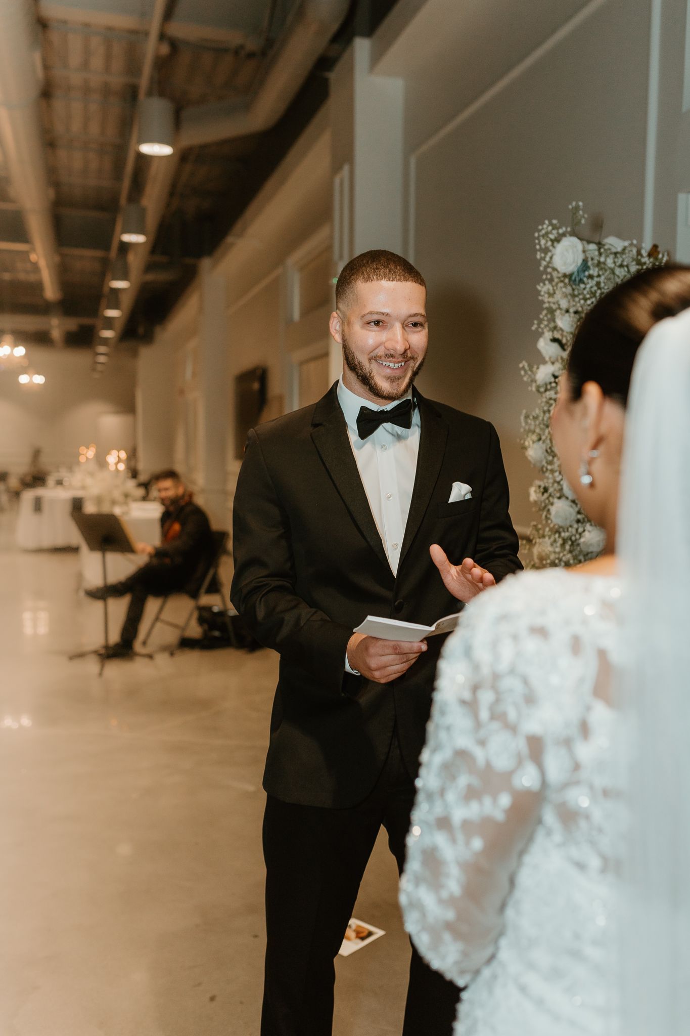 Emotional first look moment during an indoor wedding ceremony.