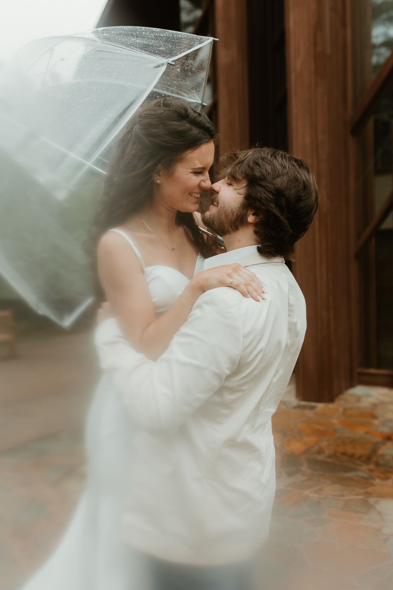 A romantic wedding moment captured with flowing veil and soft lighting in an intimate setting.