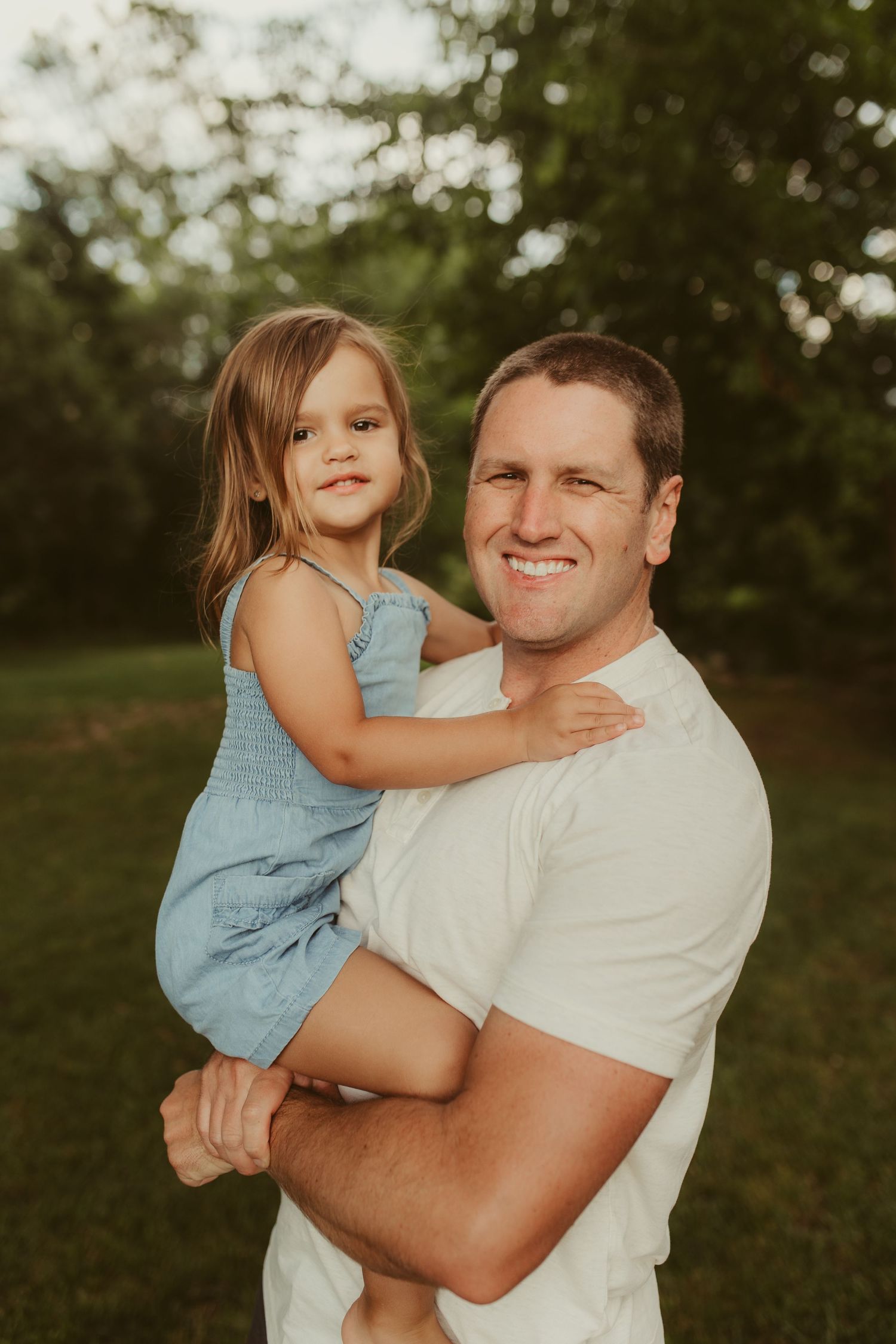 Sweet candid moments captured between parent and child outdoors during golden hour.
