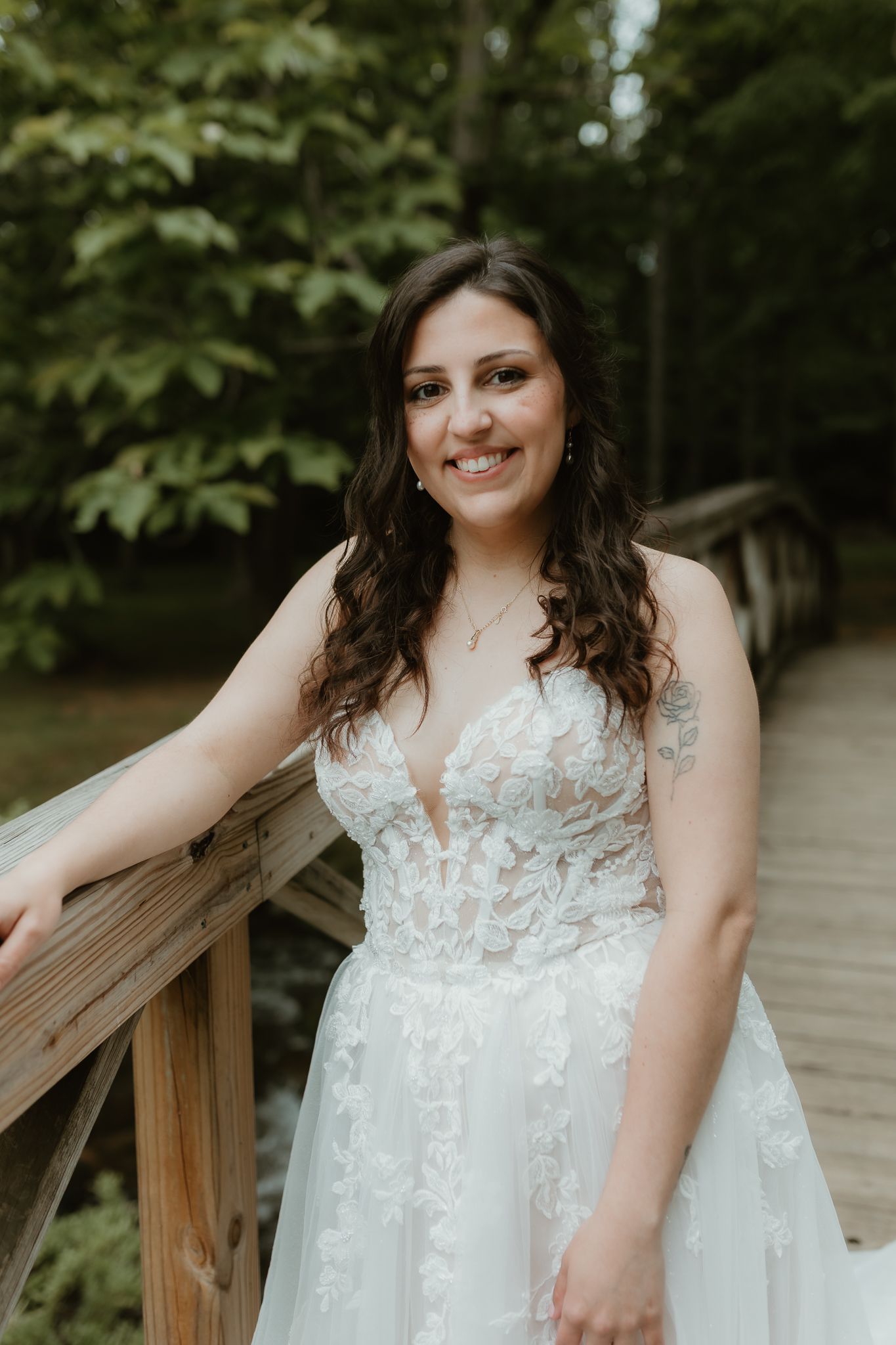 Beautiful lace wedding dress details shown in outdoor bridal portraits.