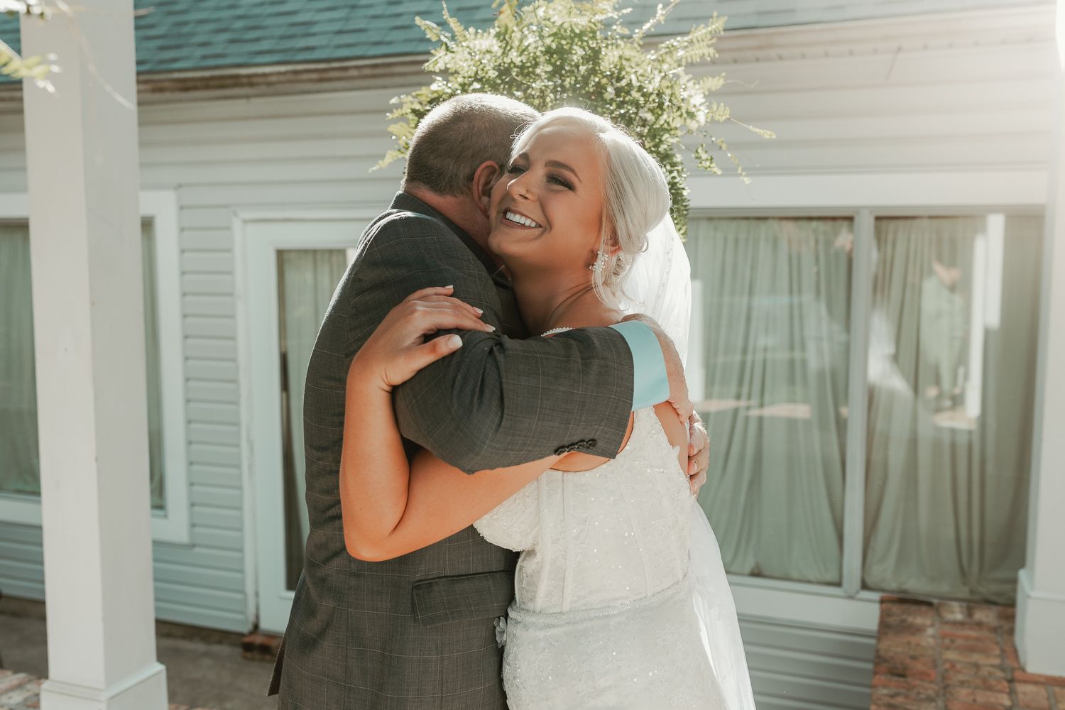 Emotional wedding day embrace captured in series of outdoor photos.