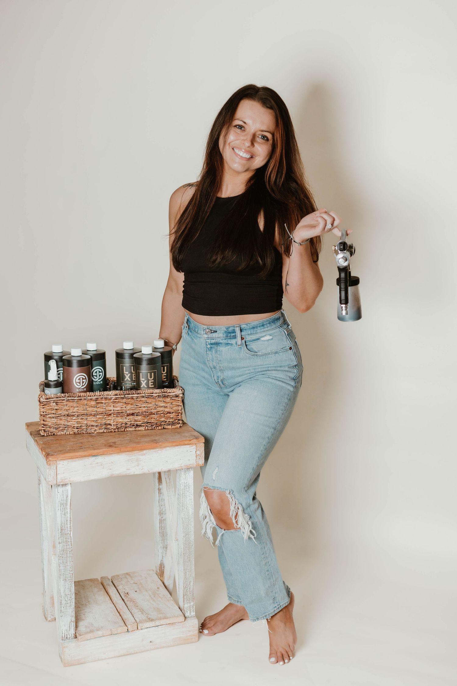 Studio photography session featuring vintage camera collection and casual styling.