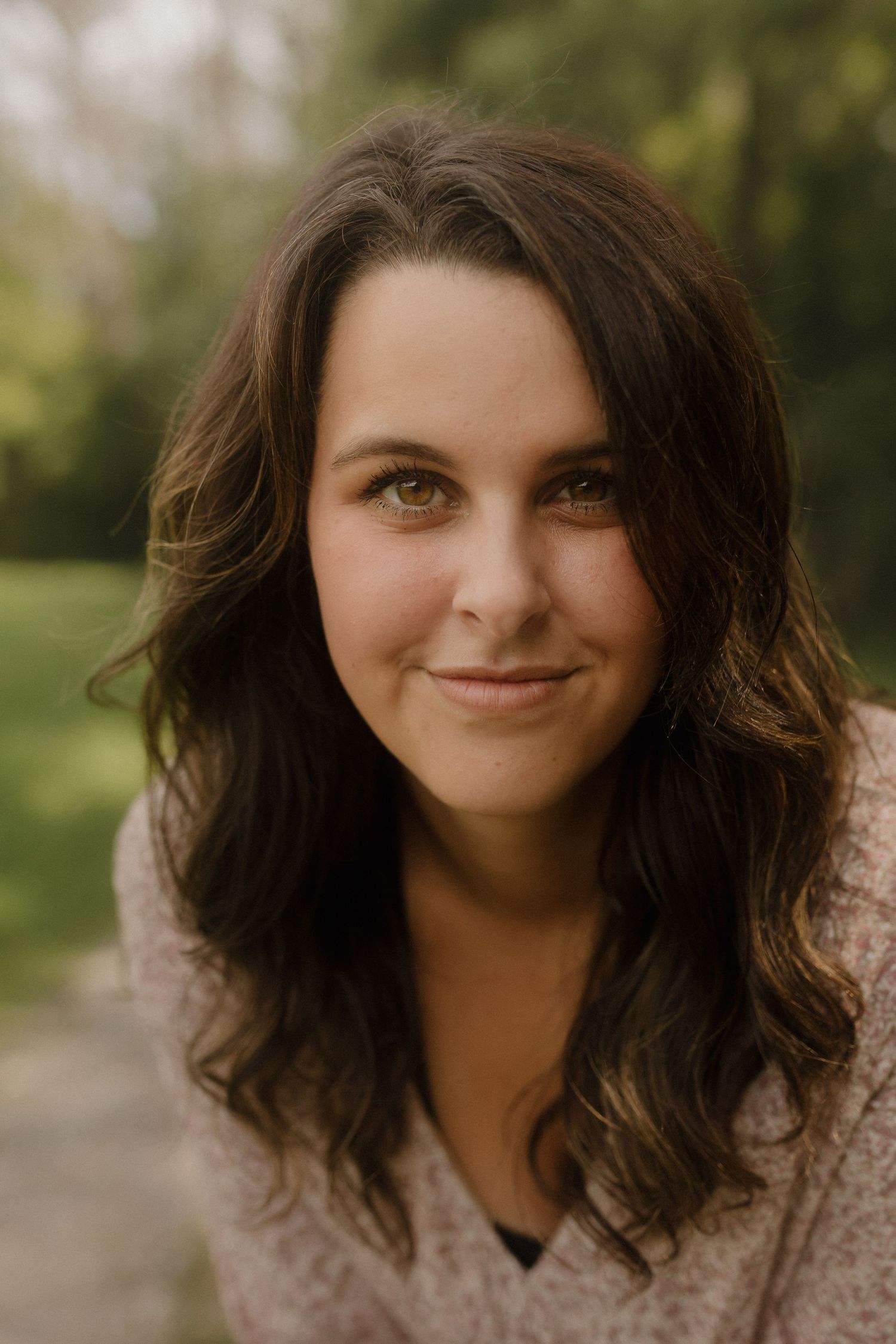 Close-up portrait series showing someone with wavy dark hair and natural makeup in warm lighting.