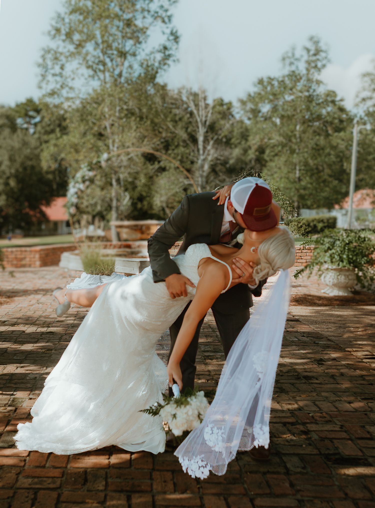 A series of wedding photos showing a couple dipping and dancing together on a brick patio.