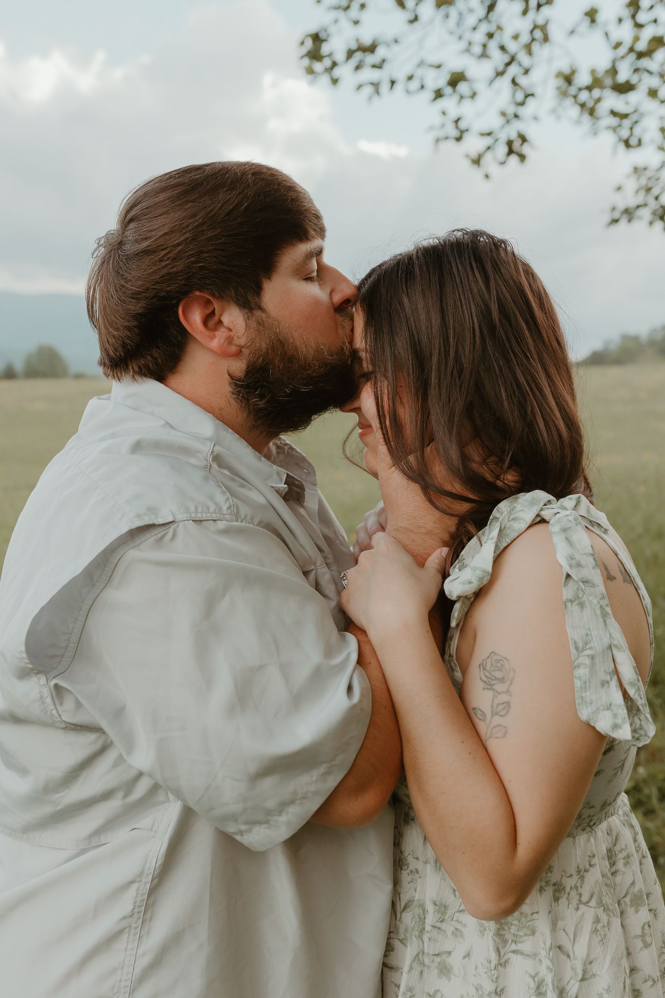 Close-up romantic portraits in a meadow with soft natural lighting.