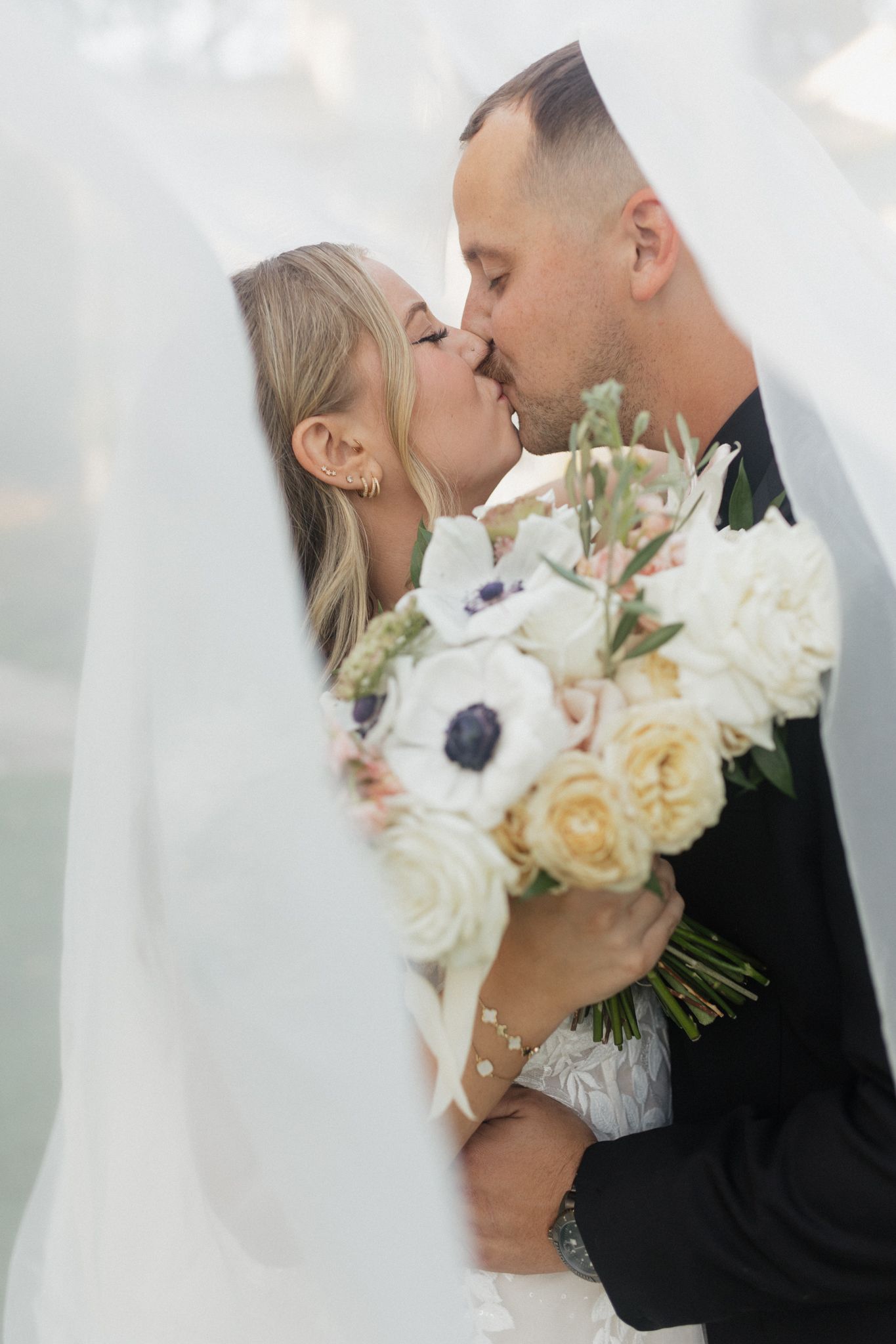 Tender wedding moment captured with elegant white and cream rose bouquet. Chattanooga Wedding Photographer