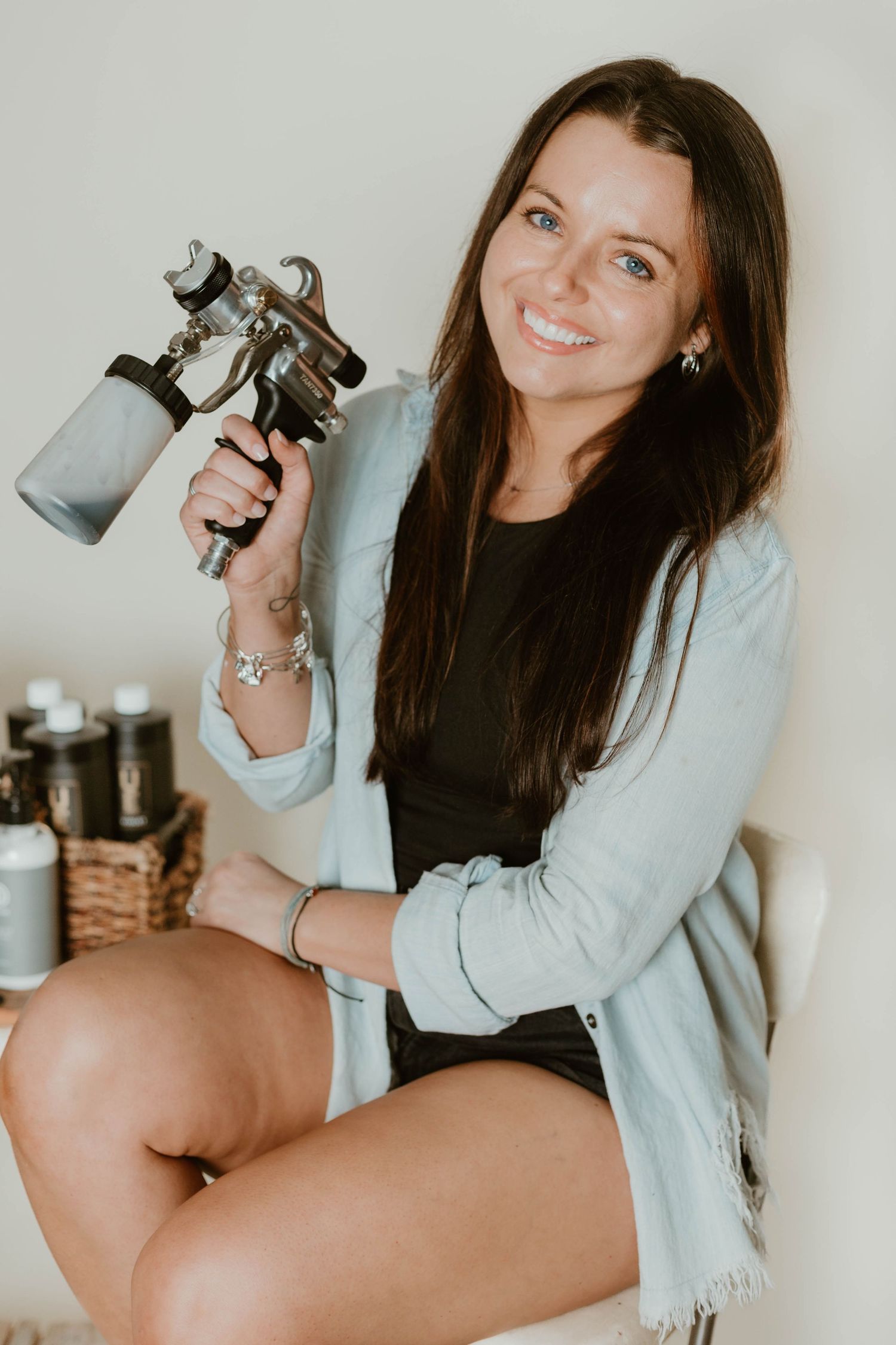 Lifestyle photography series featuring someone posing with vintage cameras against a light background.