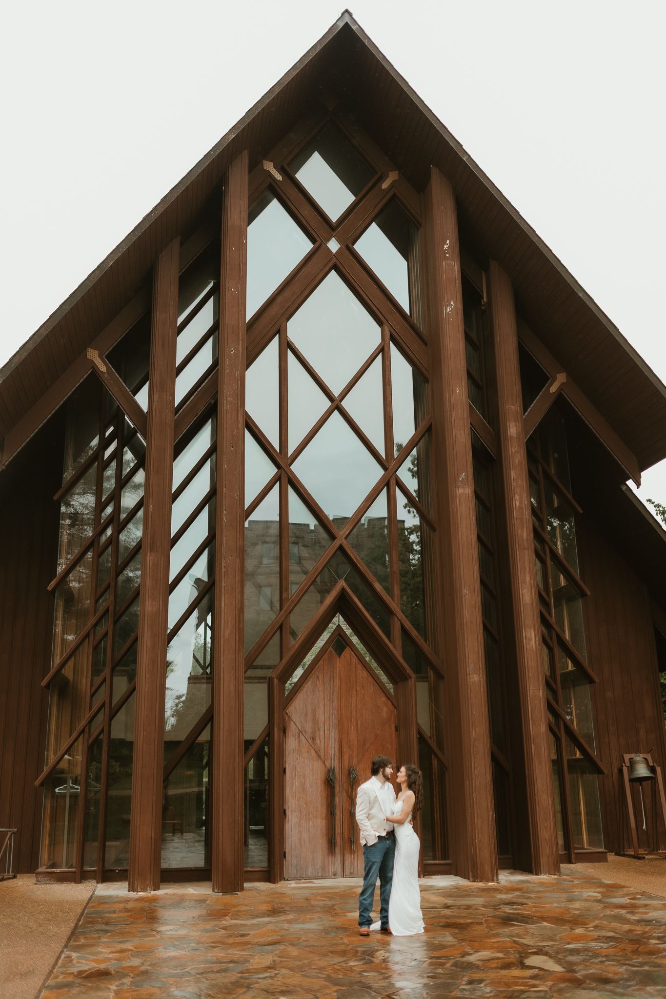 An architectural shot of wooden beams creating dramatic angles in a chapel interior.