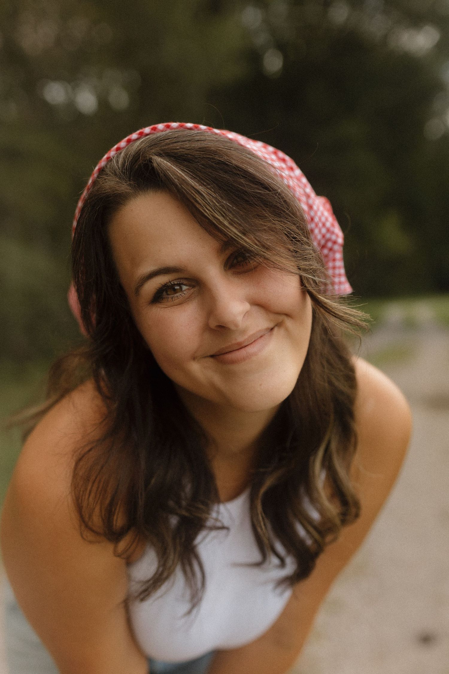A series of close-up portrait shots showing someone wearing a pink checkered headband with wavy brown hair.