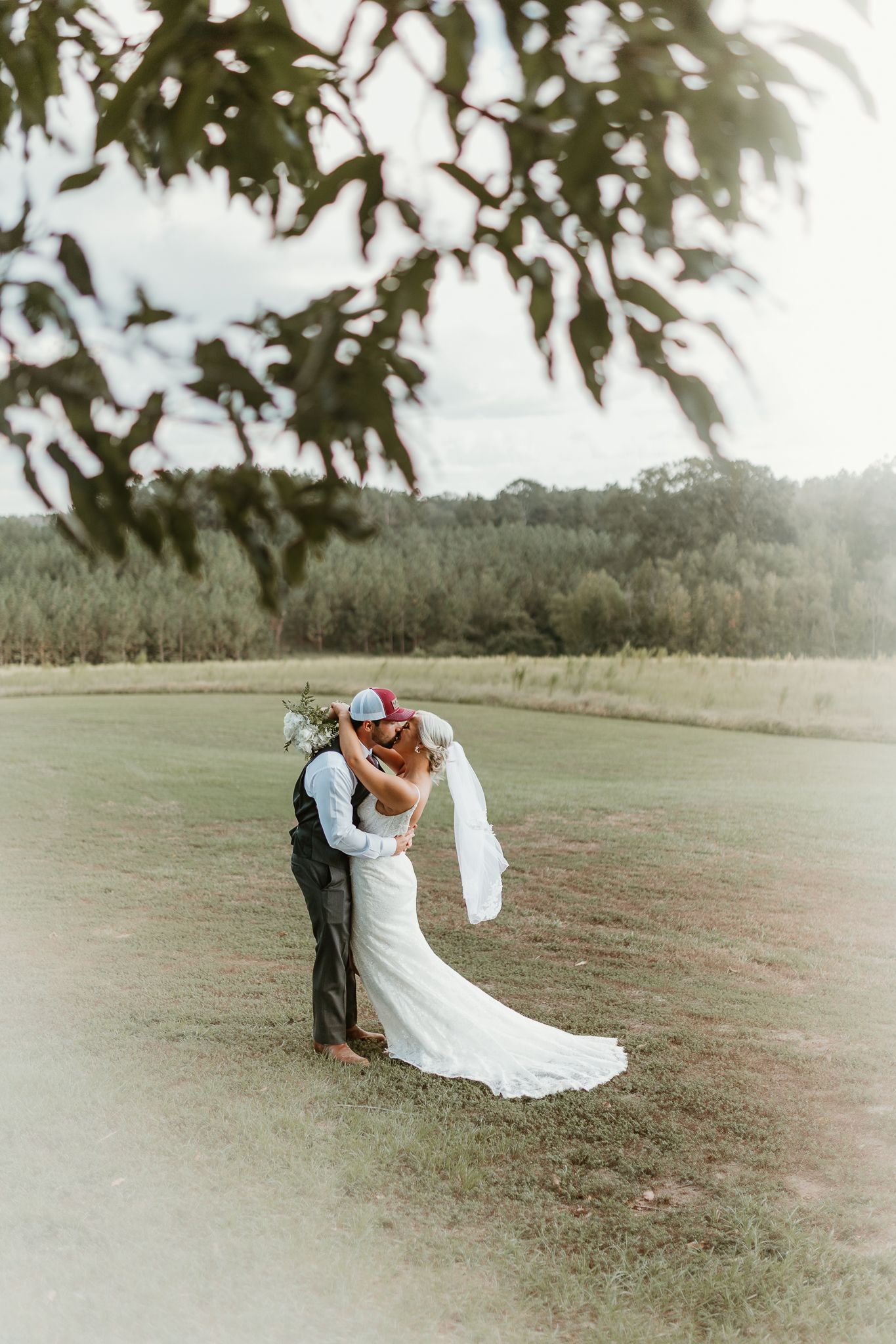 Romantic wedding couple embracing in a sunlit field with dramatic lighting Chattanooga Wedding Photographer