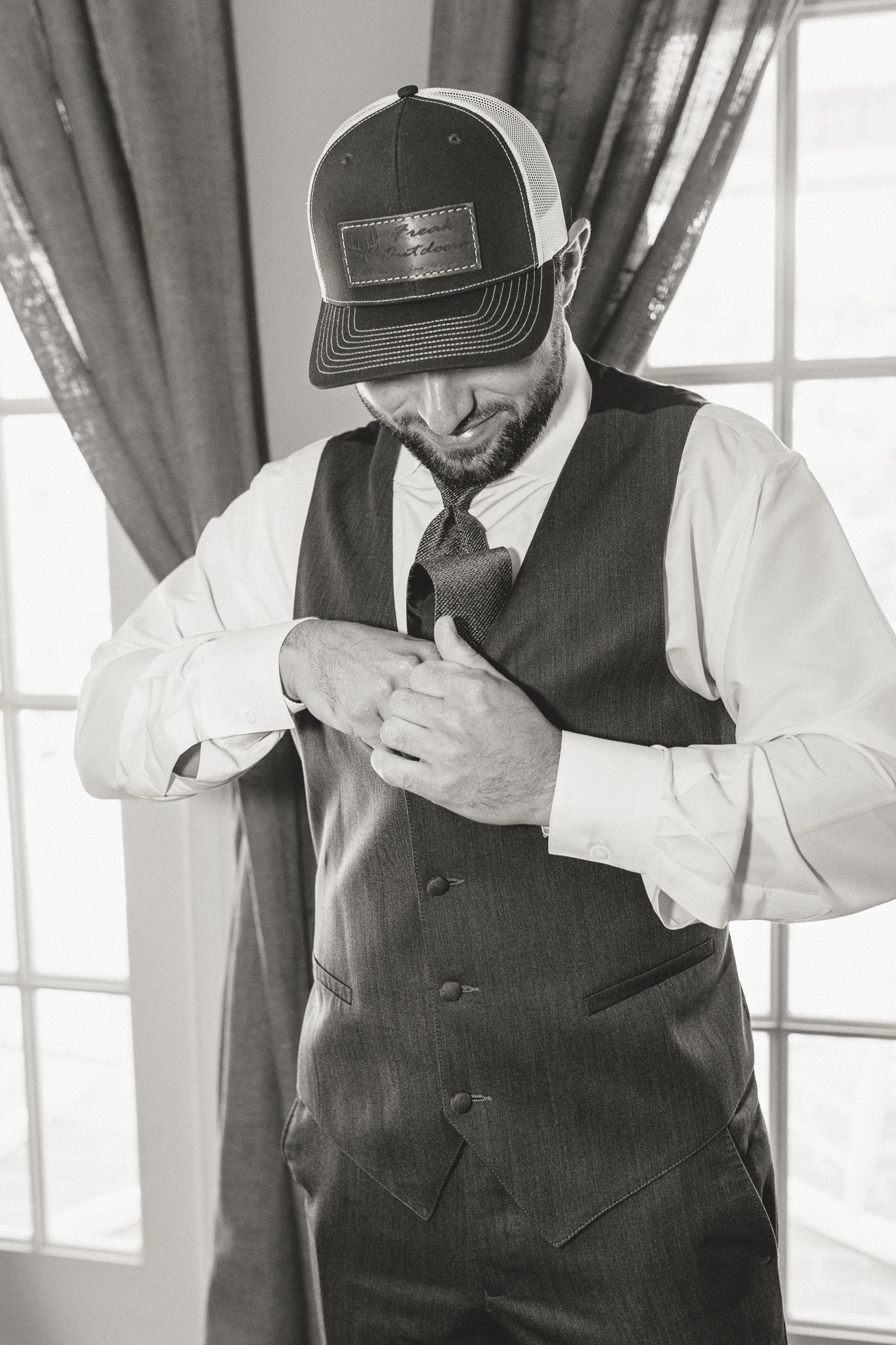 Man in formal vest and white shirt adjusting clothing in sequence of photos.