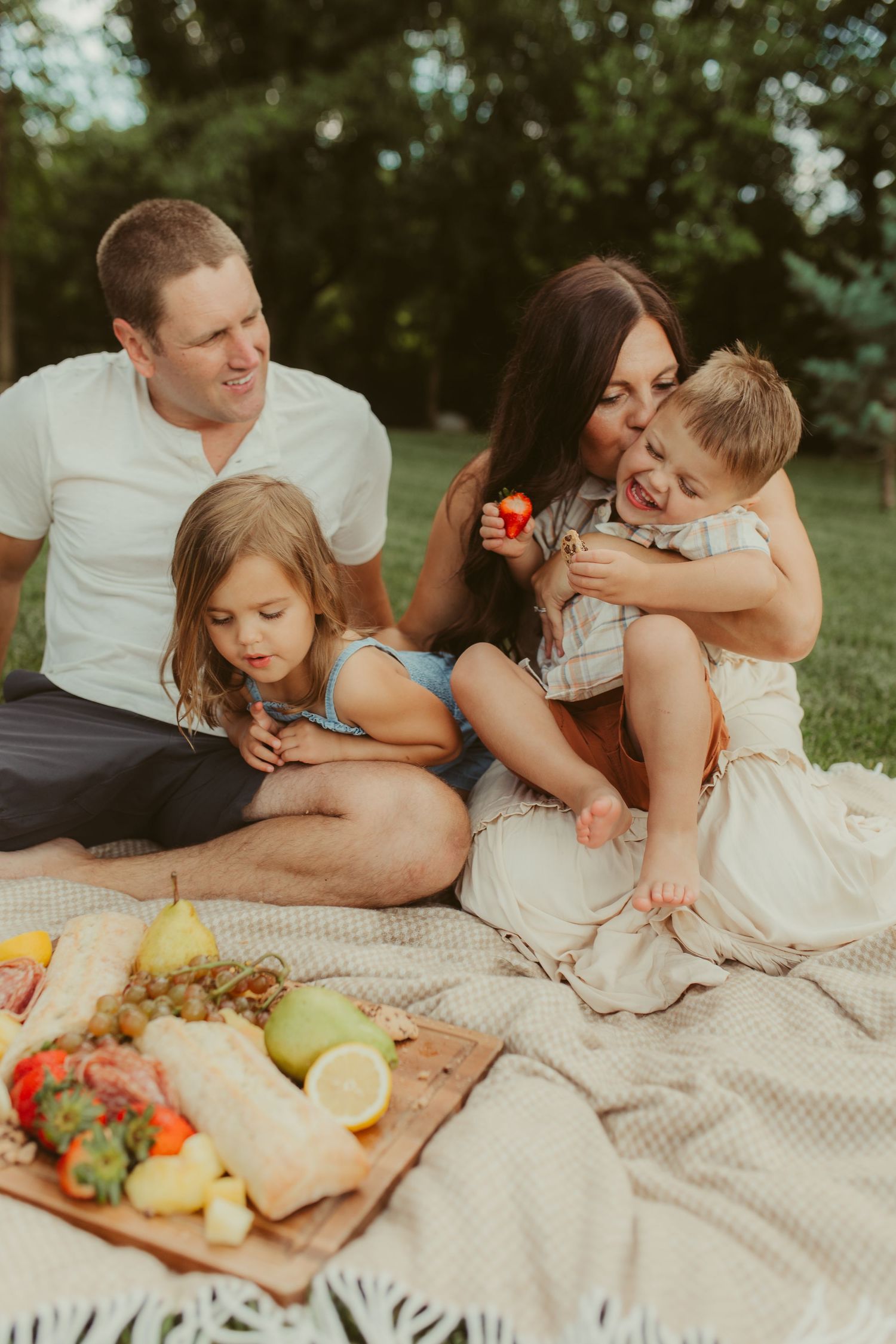 A playful family moment captured during a casual outdoor picnic photoshoot. Chattanooga Family Photographer
