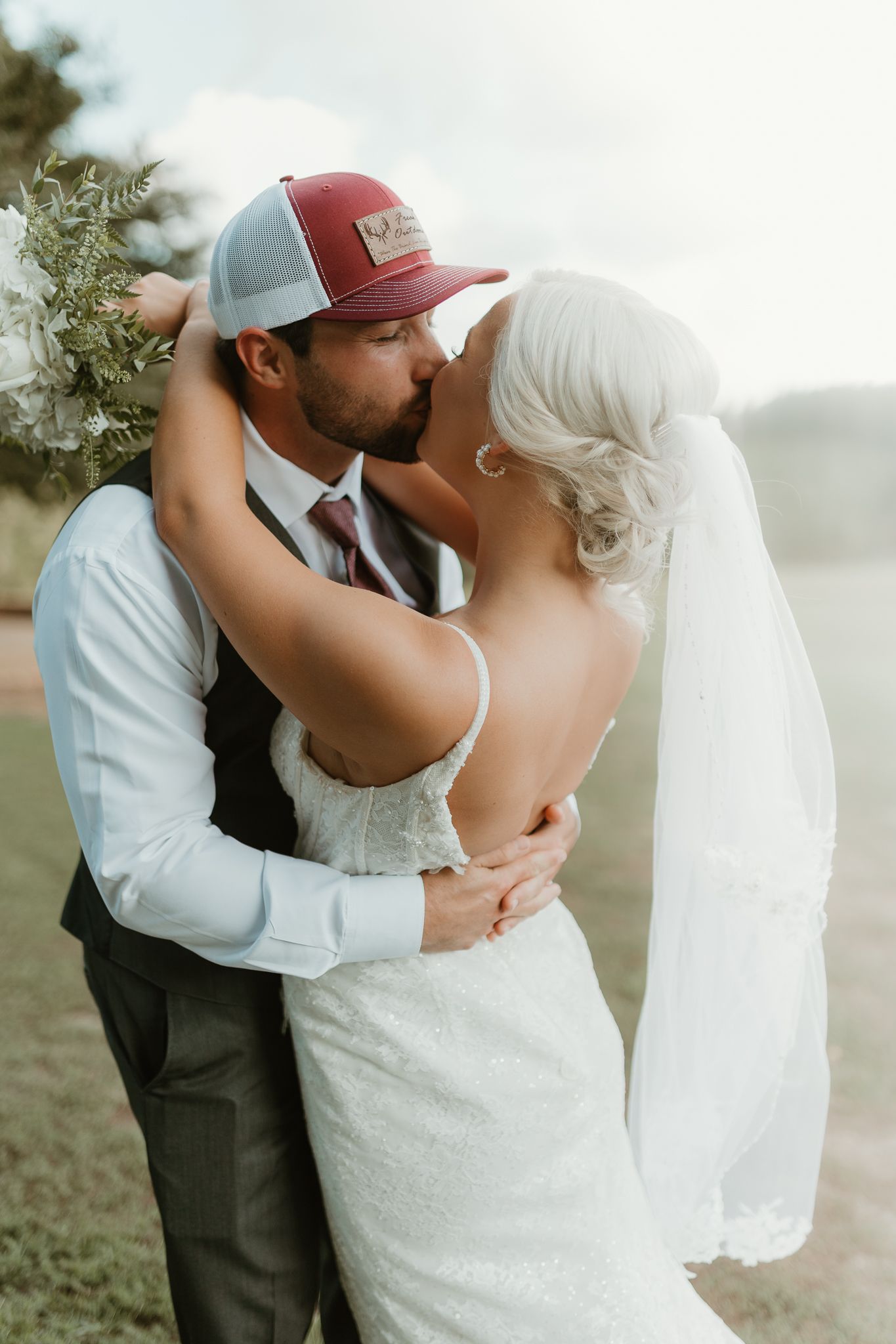 Romantic moment between newlyweds in casual attire with bride wearing white dress and veil Chattanooga Wedding Photographer