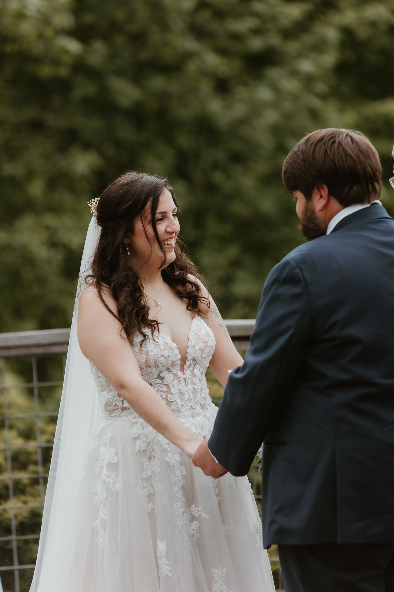 Wedding ceremony candid moments on rustic mountain deck.