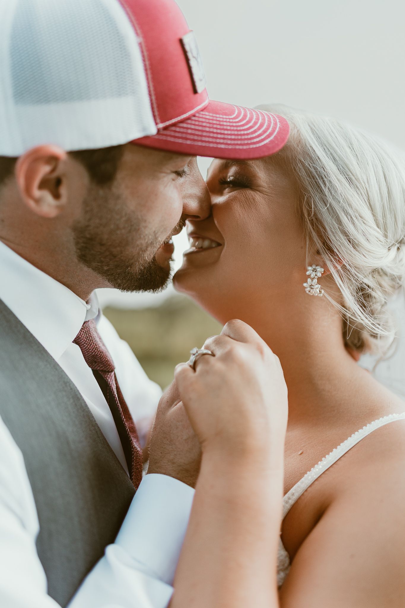 Intimate close-up shots of a couple sharing tender moments while wearing baseball caps.